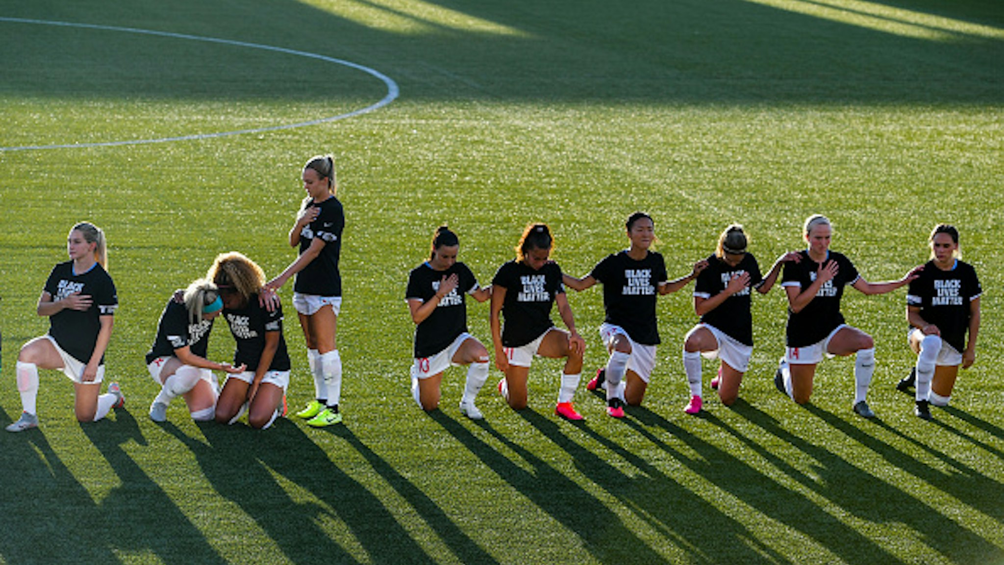 HERRIMAN, UT - JUNE 27: Julie Ertz #8 and Rachel Hill #5 console Casey Short #6 of the Chicago Red Stars as teammates kneel during the national anthem before a game against the Washington Spirit in the first round of the NWSL Challenge Cup at Zions Bank Stadium on June 27, 2020 in Herriman, Utah.