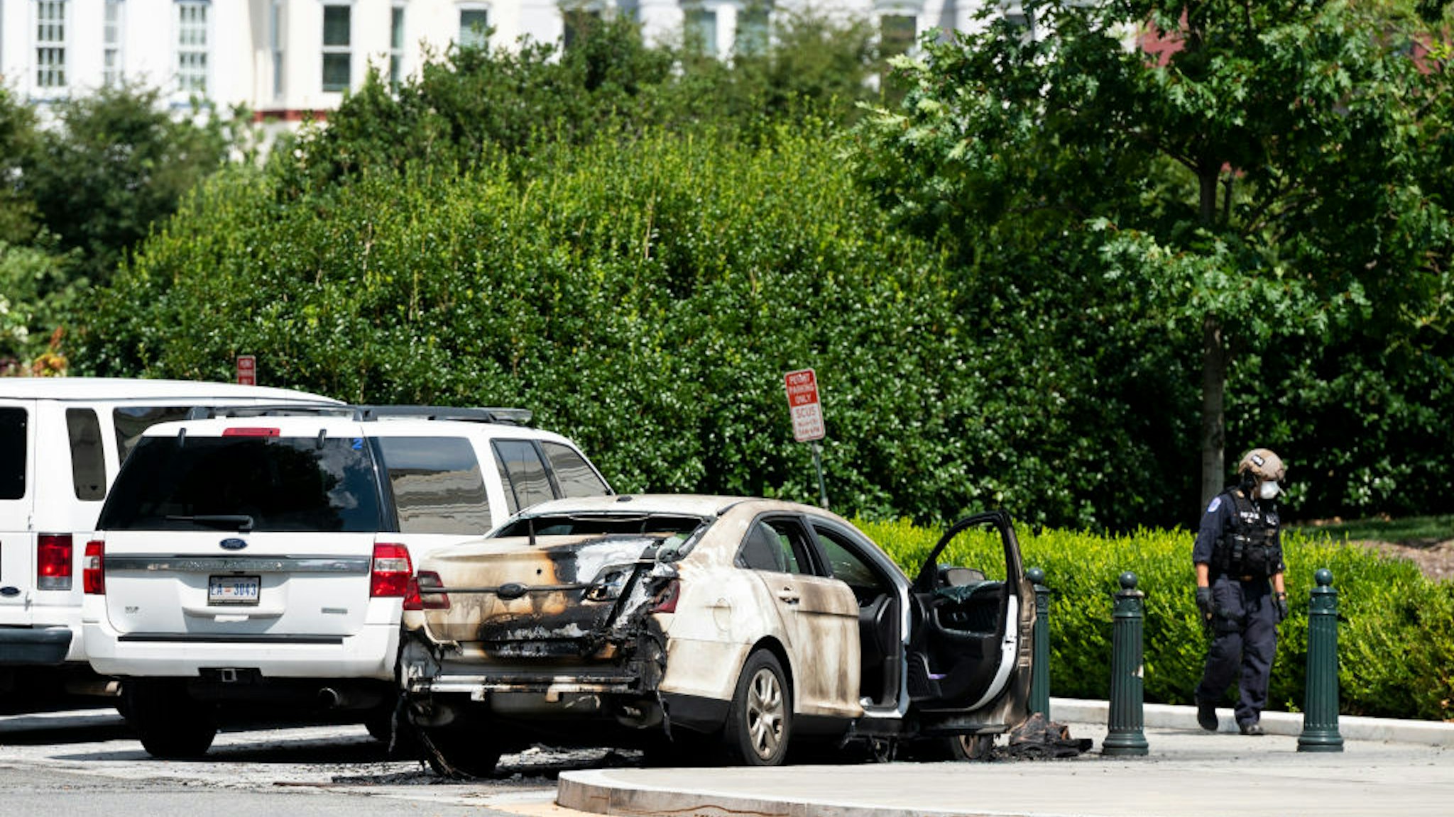 UNITED STATES - JULY 15: Police investigate a burned out car parked outside the U.S. Supreme Court building i9n Washington on Wednesday, July 15, 2020.
