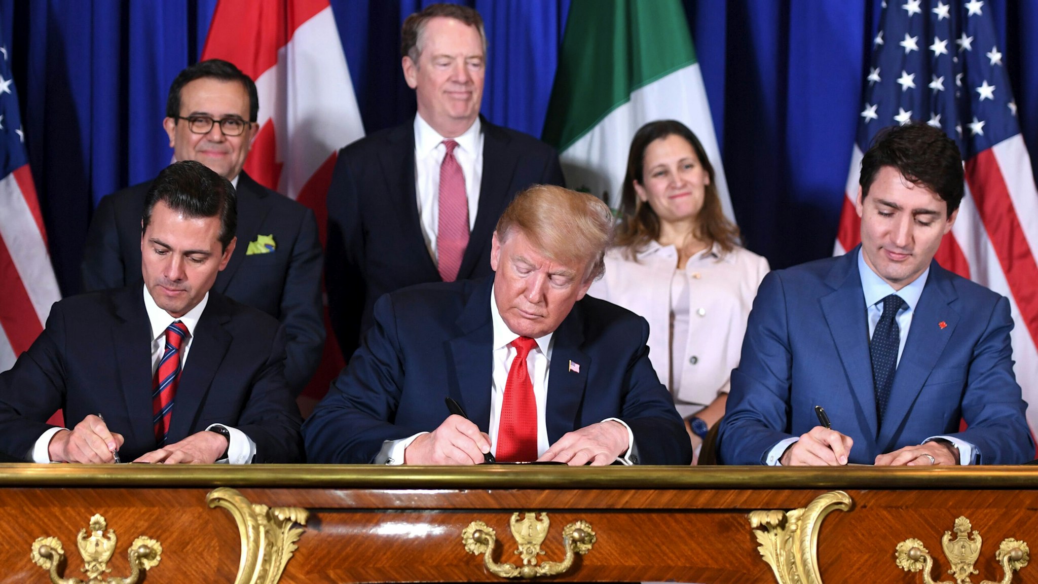Mexico's President Enrique Pena Nieto (L) US President Donald Trump (C) and Canadian Prime Minister Justin Trudeau, sign a new free trade agreement in Buenos Aires, on November 30, 2018, on the sidelines of the G20 Leaders' Summit. - The revamped accord, called the US-Mexico-Canada Agreement (USMCA), looks a lot like the one it replaces. But enough has been tweaked for Trump to declare victory on behalf of the US workers he claims were cheated by NAFTA.