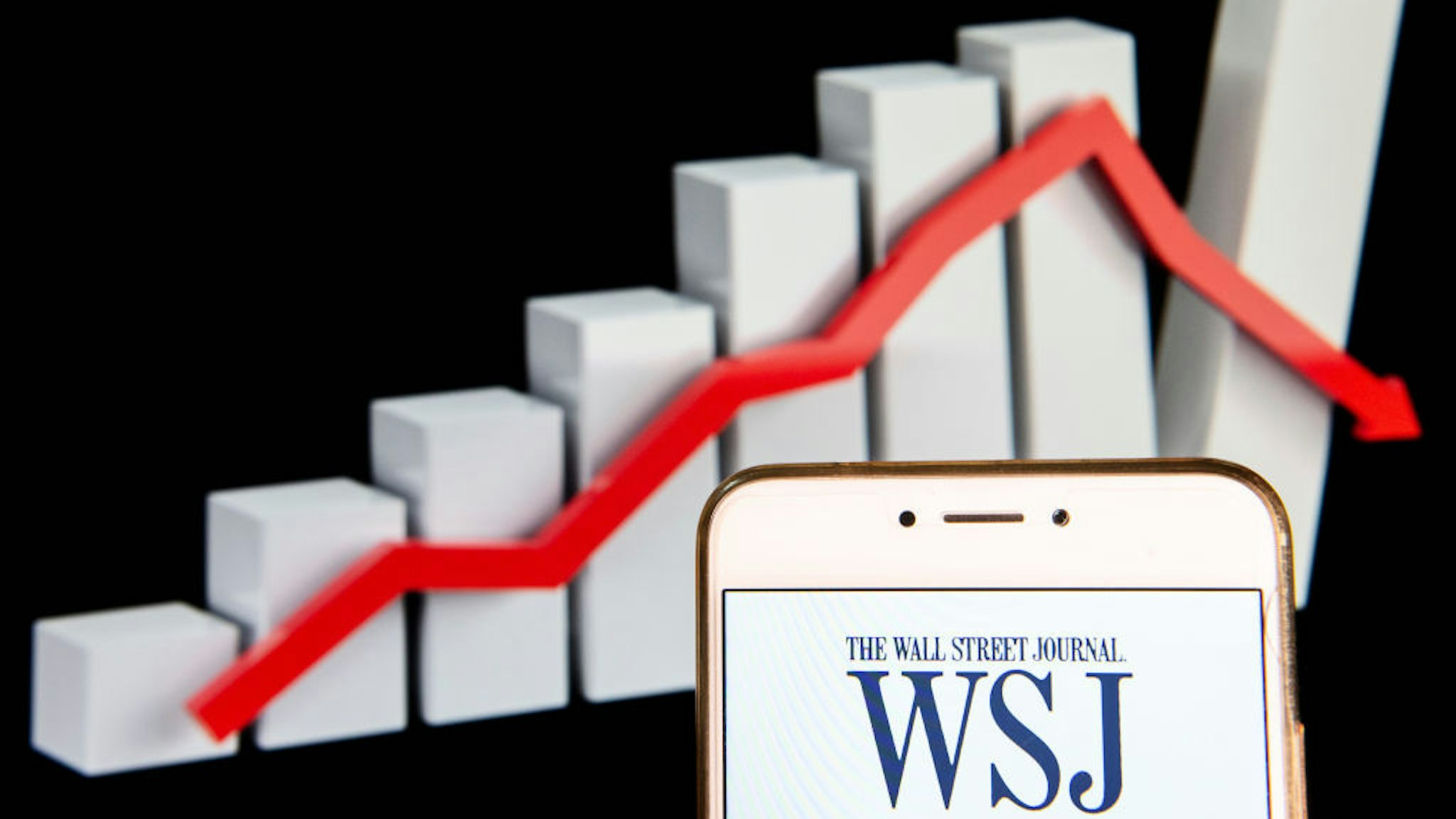 HONG KONG - 2018/12/14: American business focused international daily newspaper The Wall Street Journal logo is seen on an Android mobile device with a graph showing sharp losses in the background. (Photo by Miguel Candela/SOPA Images/LightRocket via Getty Images)