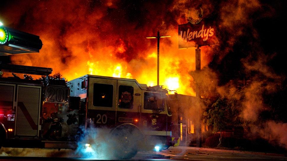 ATLANTA, USA - JUNE 13: Demonstrators set on fire a restaurant during the protest after an Atlanta police officer shot and killed Rayshard Brooks, 27, at a Wendy's fast food restaurant drive-thru Friday night in Atlanta, United States on June 13, 2020. As nationwide protests slowed in the death of George Floyd, anger again erupted Saturday in the US over the fatal shooting of another black man. Mayor Keisha Lance Bottoms announced Atlanta Police Chief Ericka Shields voluntarily stepped down from the department earlier in the day.