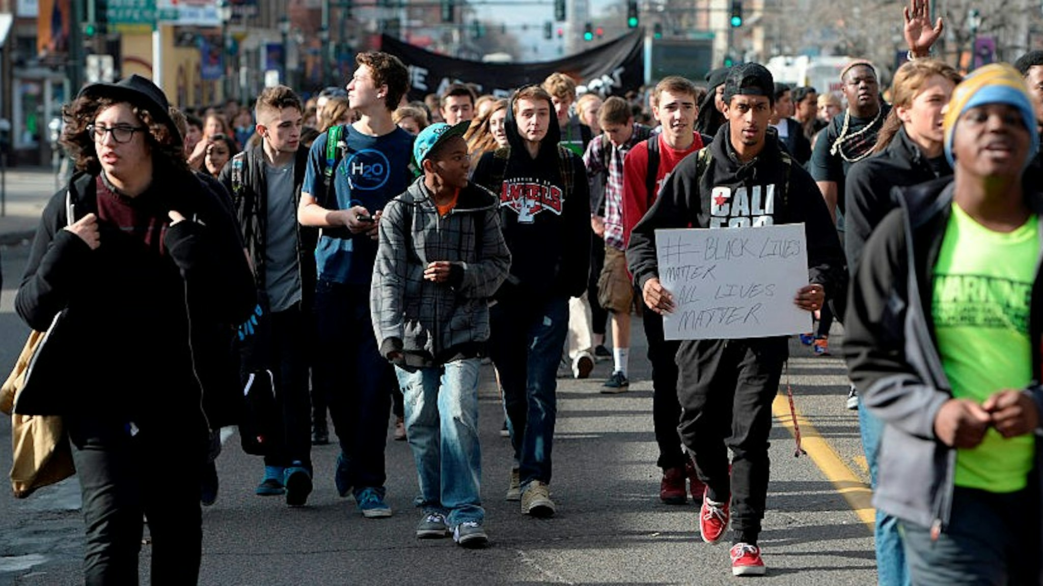 DENVER, CO - DECEMBER 03: East High School students gather and sit in the intersection of York St and Colfax Ave during a Ferguson walkout and protest only a few block east of where four Denver Police officers on bicycles were hit by a vehicle traveling west on Colfax. All of the officers were transported to Denver Health Medical center December 03, 2014 with unknown conditions. (Photo b