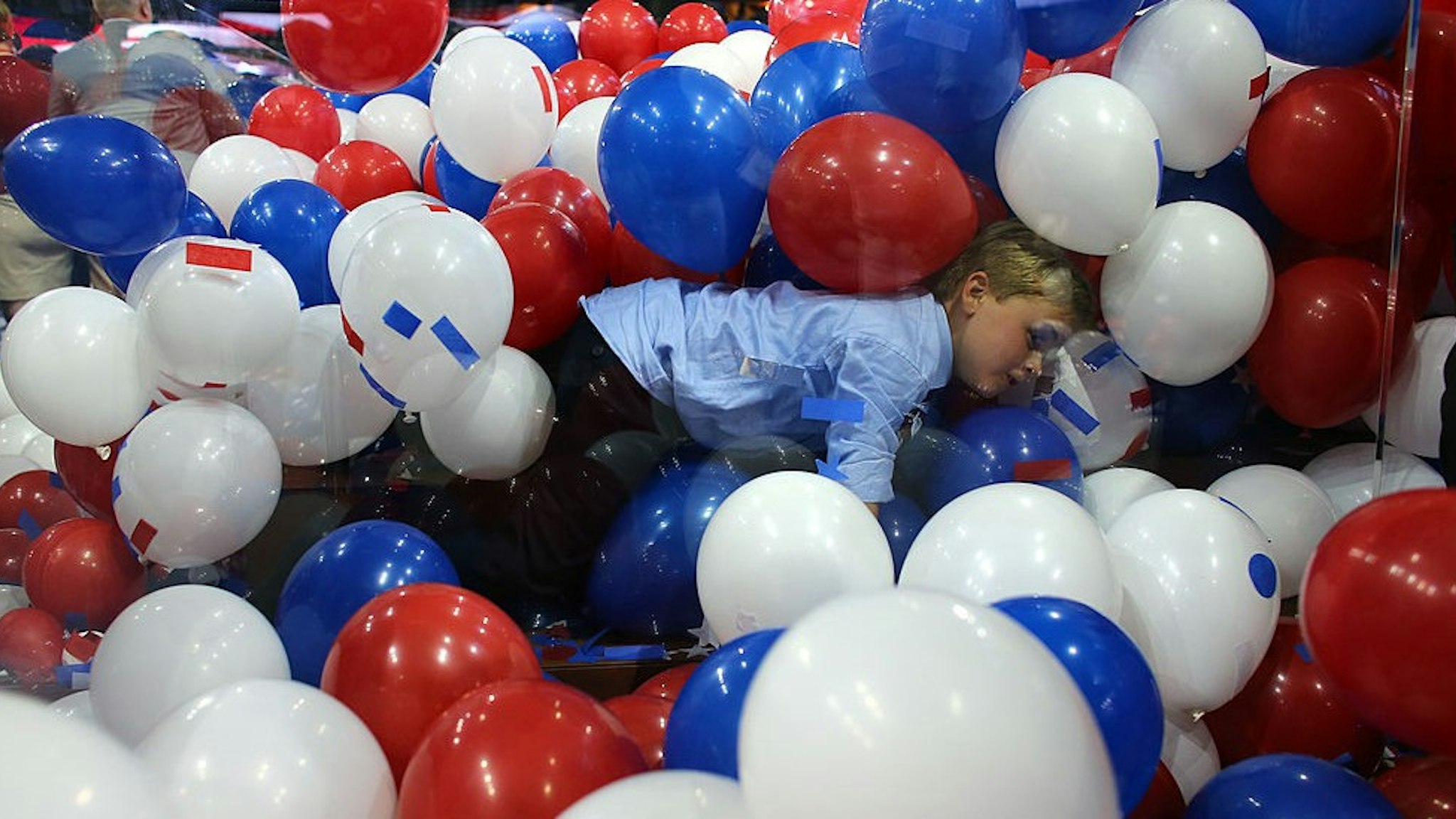 TAMPA, FL - AUGUST 30: A boy plays in the balloons after Republican presidential candidate, former Massachusetts Gov. Mitt Romney accepted the nomination during the final day of the Republican National Convention at the Tampa Bay Times Forum on August 30, 2012 in Tampa, Florida. Former Massachusetts Gov. Mitt Romney was nominated as the Republican presidential candidate during the RNC which will conclude today. (Photo by
