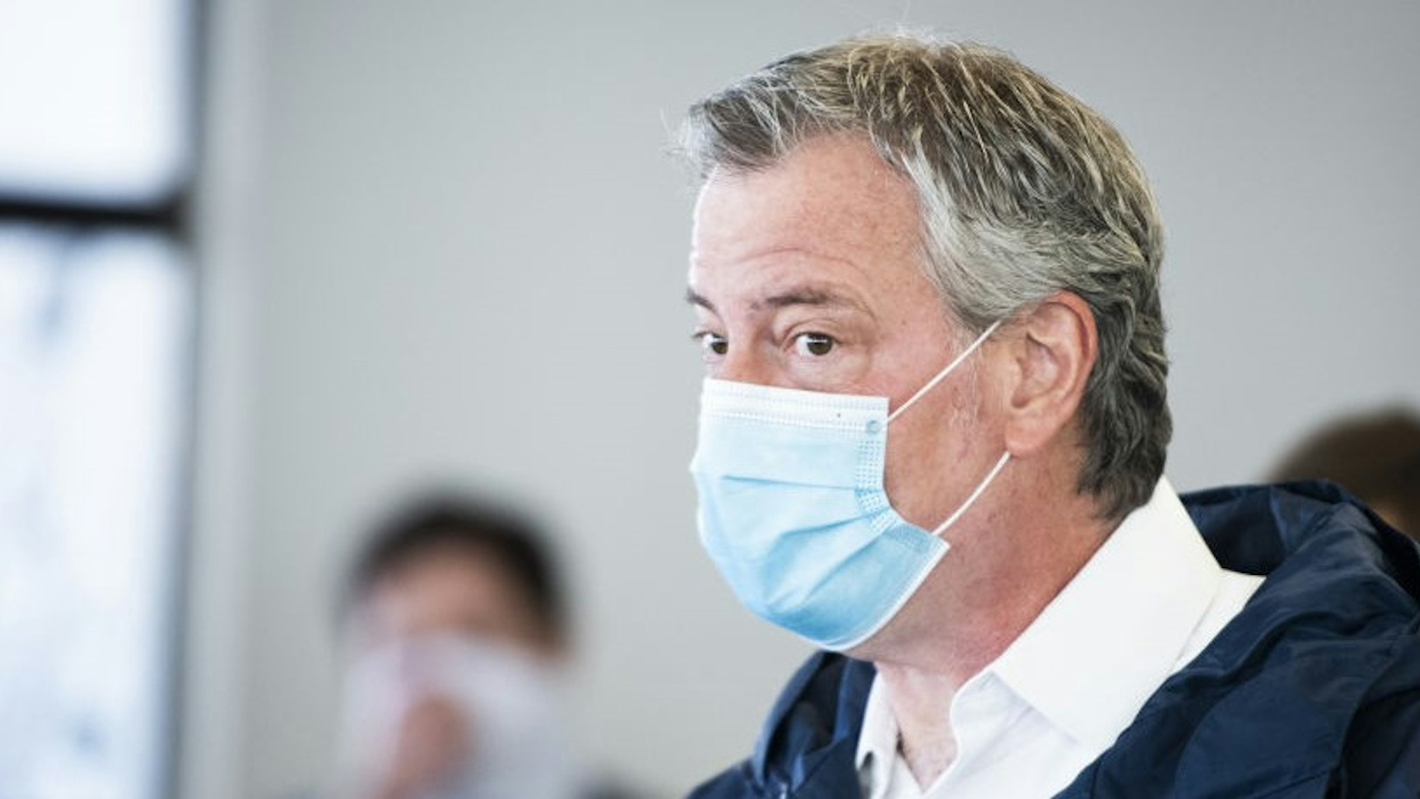 Bill de Blasio, mayor of New York, wears a protective mask while touring the Malia Mills swimwear factory, which has pivoted to manufacturing polypropylene gowns for medical workers, in the Brooklyn borough of New York, U.S., on Wednesday, April 22, 2020. New York City officials intend to enlist thousands of health-care workers next month to conduct hundreds of thousands of diagnostic tests a day, and isolating anyone found to be carrying the disease. Photographer: