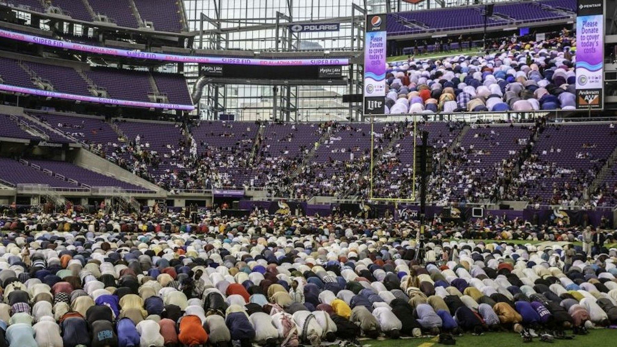 Muslim worshippers kneel in prayer at the US Bank Stadium during celebrations for Eid al-Adha on August 21, 2018 in Minneapolis, Minnesota.