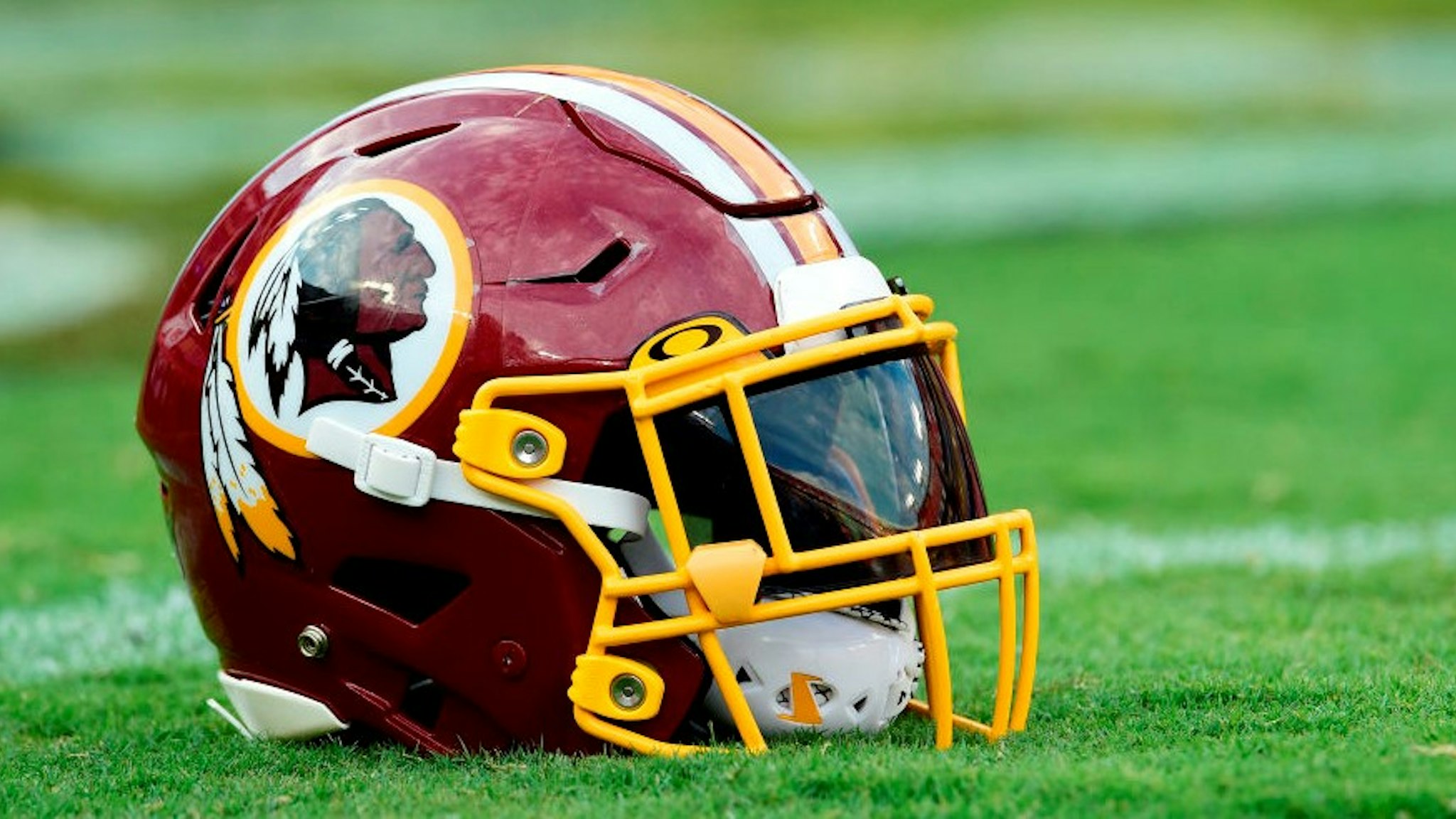 LANDOVER, MD - AUGUST 15: A Washington Redskins helmet sits on the field before a preseason game between the Cincinnati Bengals and Redskins at FedExField on August 15, 2019 in Landover, Maryland. (Photo by