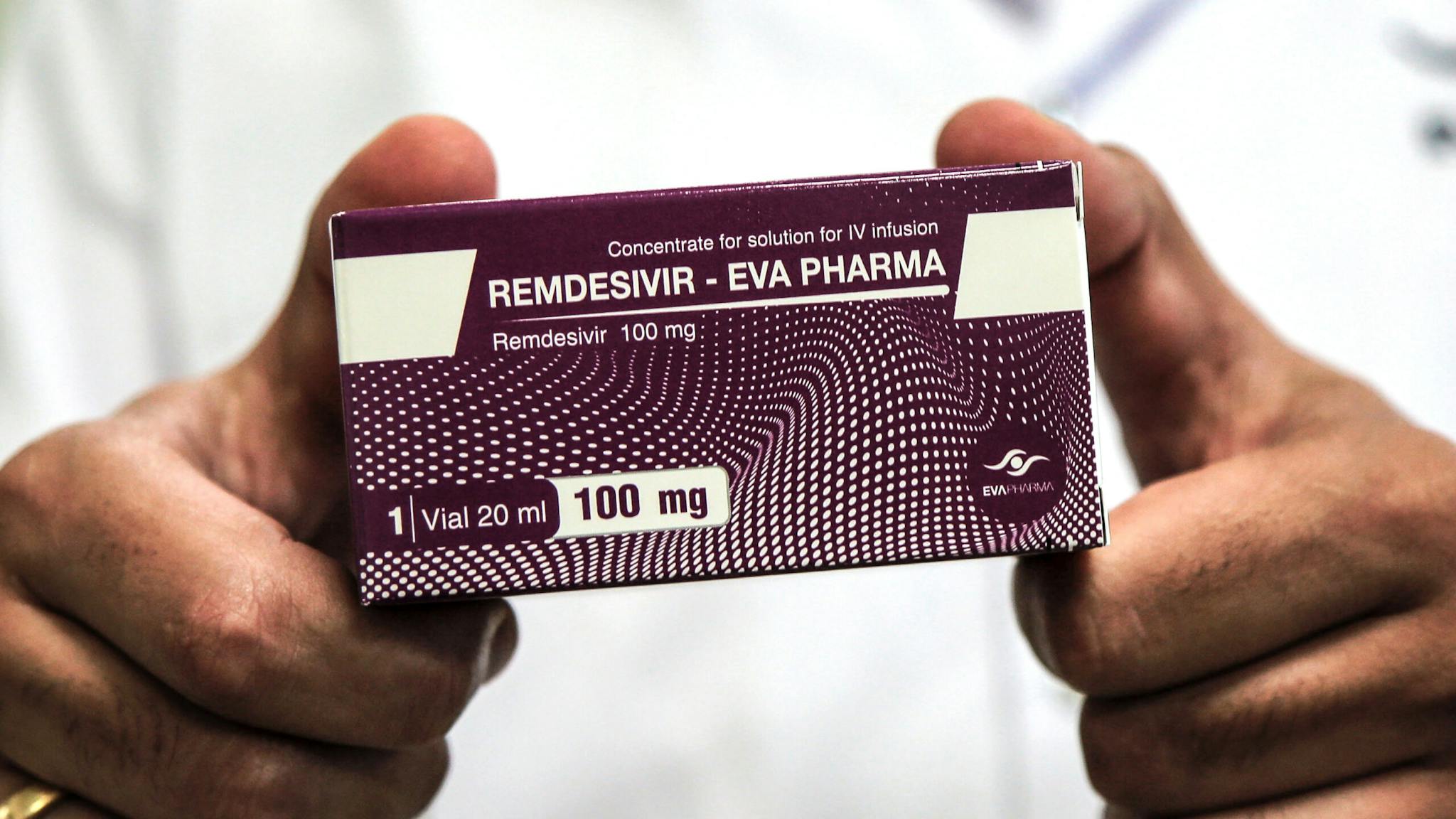 COVID-19 medicine production in Egypt 29 June 2020, Egypt, Giza: An employee of Egyptian pharmaceutical company Eva Pharma holds a pack containing vials of Remdesivir, a broad-spectrum antiviral medication approved as a specific treatment for COVID-19, at the company's factory, which started producing the drug this week with a production capacity of up to 1.5 million doses per month.