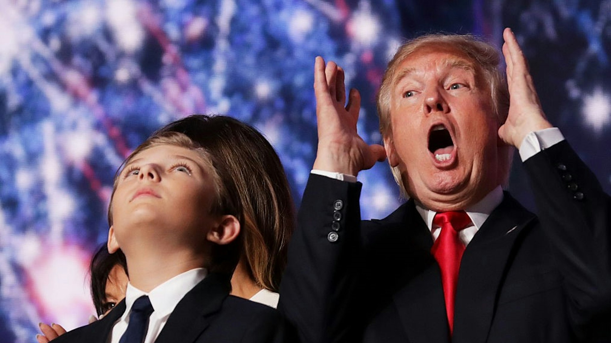 CLEVELAND, OH - JULY 21: Republican presidential candidate Donald Trump reacts as his son Barron Trump looks on at the end of the Republican National Convention on July 21, 2016 at the Quicken Loans Arena in Cleveland, Ohio. Republican presidential candidate Donald Trump received the number of votes needed to secure the party's nomination. An estimated 50,000 people are expected in Cleveland, including hundreds of protesters and members of the media. The four-day Republican National Convention kicked off on July 18. (Photo by