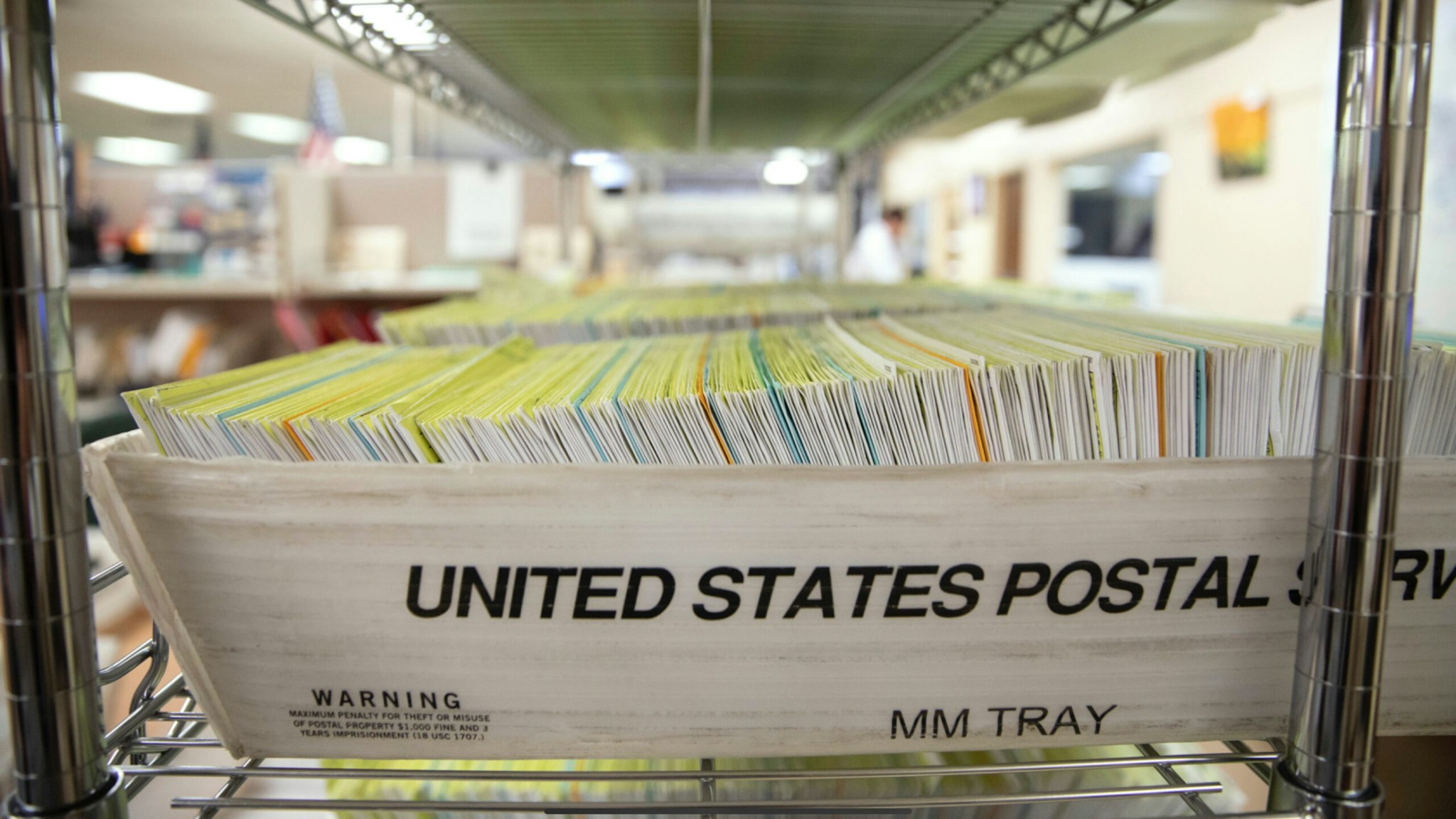 Mailed in ballots sit in US Postal Service bins inside the office of the Stanislaus County Clerk on November 6, 2018 in Modesto, California.