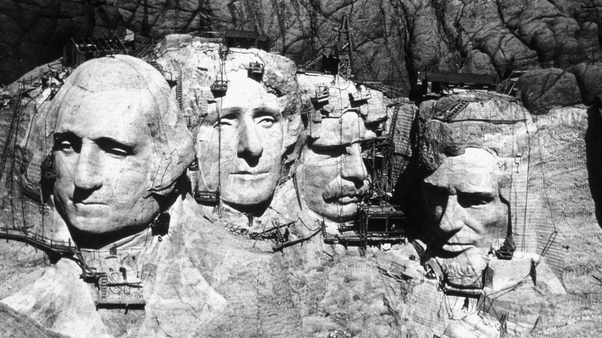 The memorial at Mount Rushmore, South Dakota under construction. The four heads are those of Presidents George Washington (1732 - 1799), Thomas Jefferson (1743 - 1826), Theodore Roosevelt (1858 - 1919) and Abraham Lincoln (1809 - 1865).