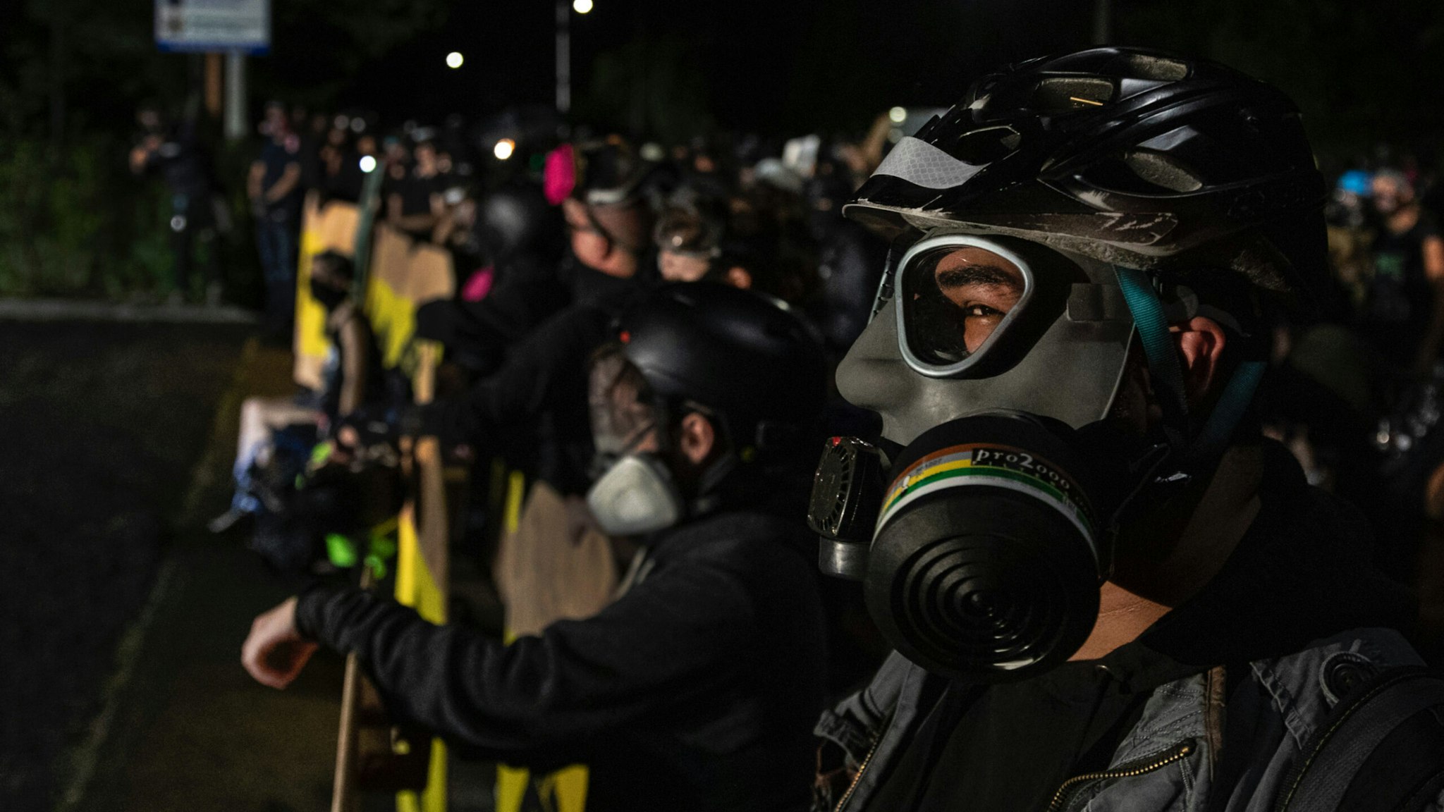 Protesters are seen during a standoff at a Portland police precinct in Portland, Oregon on August 15, 2020.
