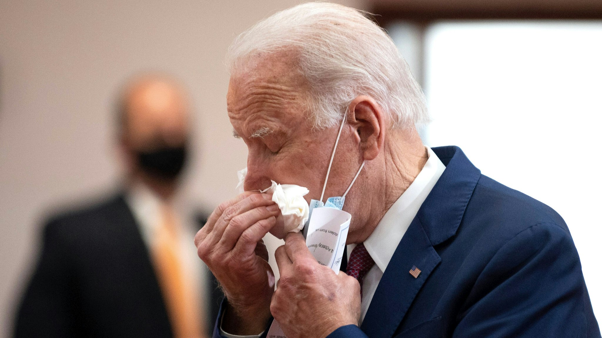 Former vice president and Democratic presidential candidate Joe Biden uses a tissue as he meets with clergy members and community activists during a visit to Bethel AME Church in Wilmington, Delaware on June 1, 2020. - Democratic presidential candidate Joe Biden visited the scene of an anti-racism protest in the state of Delaware on May 31, 2020, saying that the United States was "in pain". "We are a nation in pain right now, but we must not allow this pain to destroy us," Biden wrote in Twitter, posting a picture of him speaking with a black family at the cordoned-off site where a protesters had gathered on Saturday night.