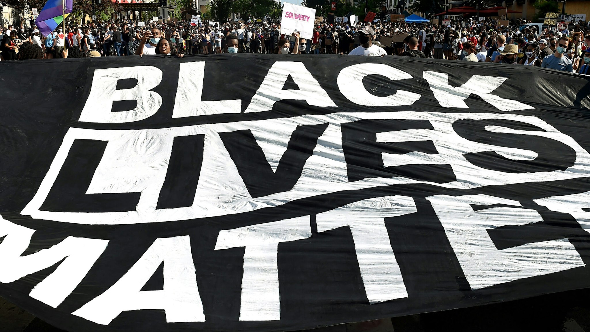 TOPSHOT - Demonstrators deploy a " Black Lives Matter" banner near the White House during a demonstration against racism and police brutality, in Washington, DC on June 6, 2020. - Demonstrations are being held across the US following the death of George Floyd on May 25, 2020, while being arrested in Minneapolis, Minnesota.