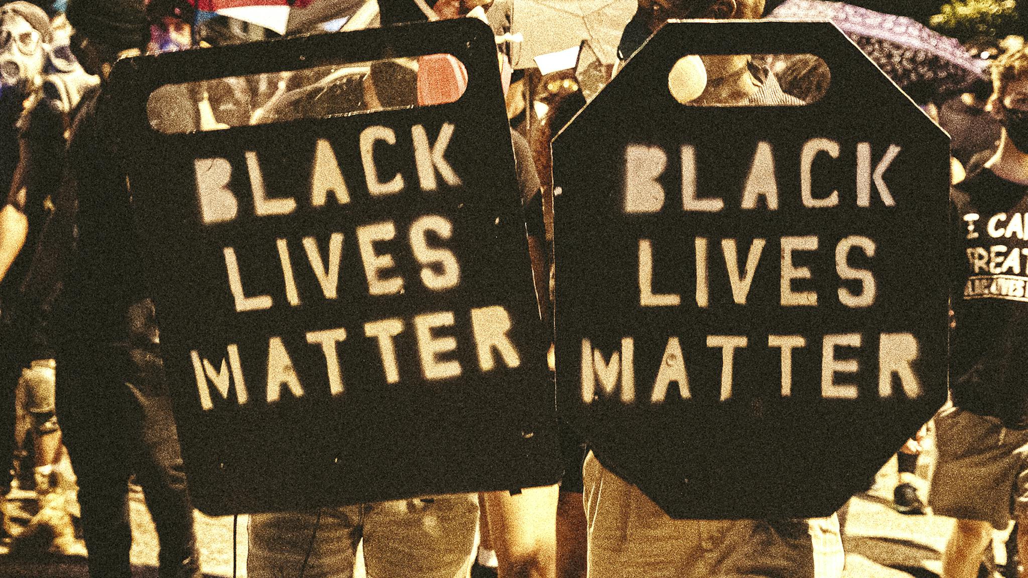 Protestors In Richmond, VA Hold Rally In Support Of Portland RICHMOND, VA - JULY 25: People carrying homemade Black Lives Matter shields march in front of protesters on July 25, 2020 in Richmond, Virginia. Protesters in Richmond took to the streets to join other protesters around the country for the Stand With Portland rally in support of the Black Lives Matter protesters in Portland, Oregon.