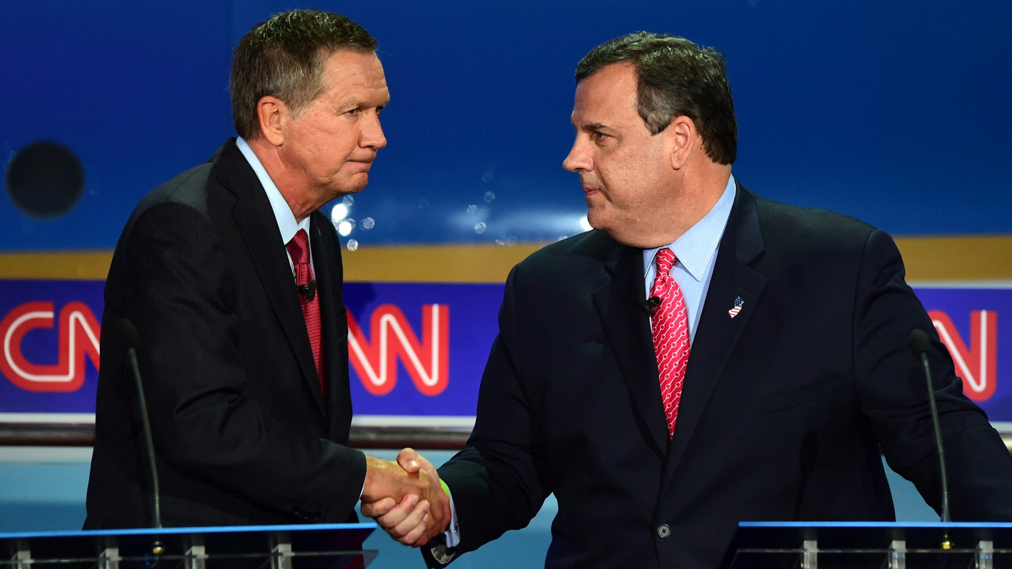 Republican presidential hopefuls, Ohio Gov. John Kasich (L) shakes hands with New Jersey Gov. Chris Christie during the Presidential debate at the Ronald Reagan Presidential Library in Simi Valley, California on September 16, 2015. Republican presidential frontrunner Donald Trump stepped into a campaign hornet's nest as his rivals collectively turned their sights on the billionaire in the party's second debate of the 2016 presidential race.