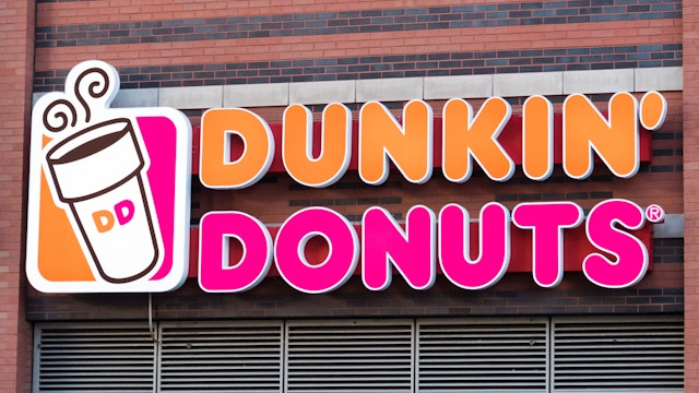NEW YORK CITY, NEW YORK, UNITED STATES - 2015/10/17: Dunkin' Donuts sign or logo outside restaurant. Dunkin' Donuts is an American global doughnut company and coffee house chain. It was founded in 1950 by William Rosenberg.