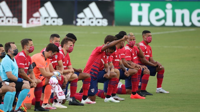 FRISCO, TX - AUGUST 12: FC Dallas Team get to their knees during the national anthem prior the game game between FC Dallas and Nashville SC as part of the Major League Soccer 2020 at Toyota Stadium on August 12, 2020 in Frisco, Texas. (Photo by Omar Vega/Getty Images)
