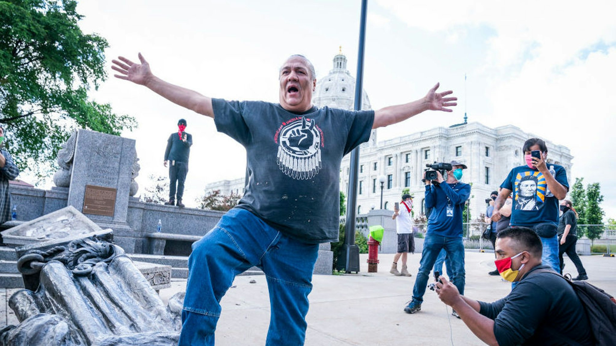 SAINT PAUL, MN,- JUNE 10: Mike Forcia, of the Black River Anishinabe, celebrated after the Christopher Columbus statue was toppled in front of the Minnesota State Capitol in St. Paul on Wednesday, June 10, 2020.