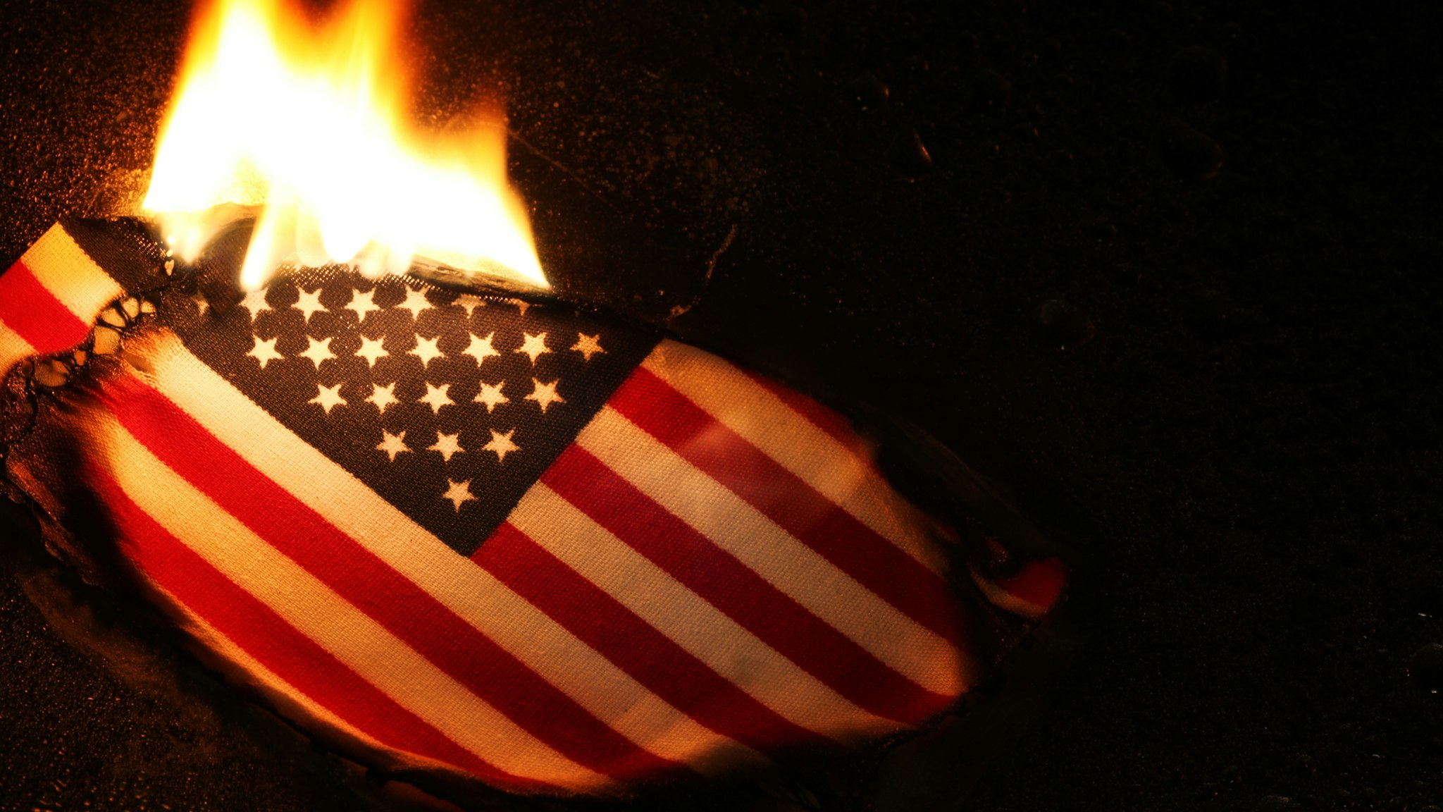 Burning American flag, perhaps in protest