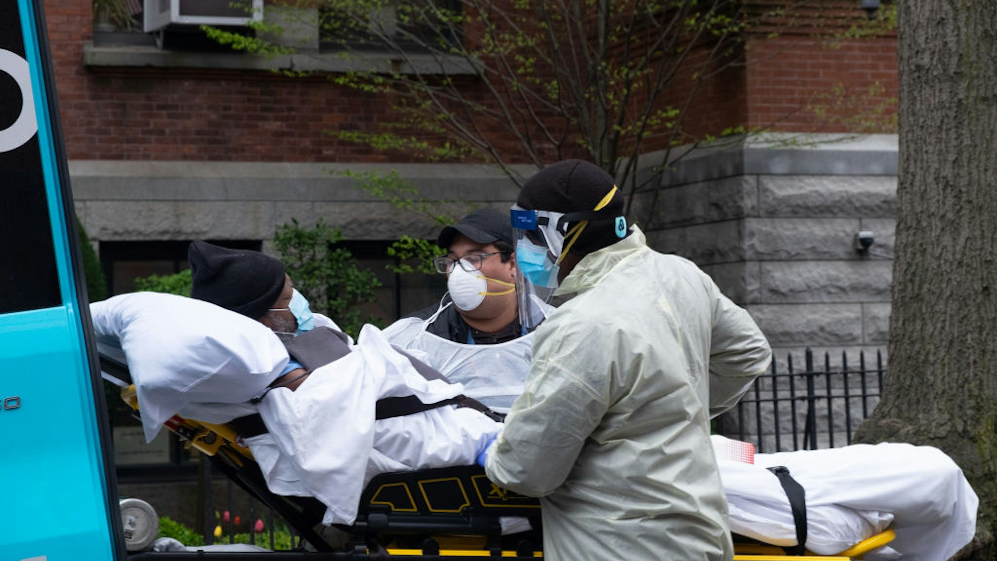 Ambulance workers pickup an elderly man from Cobble Hill Health Center, the nursing home that recently registered an alarming amount of covid-19 deaths.