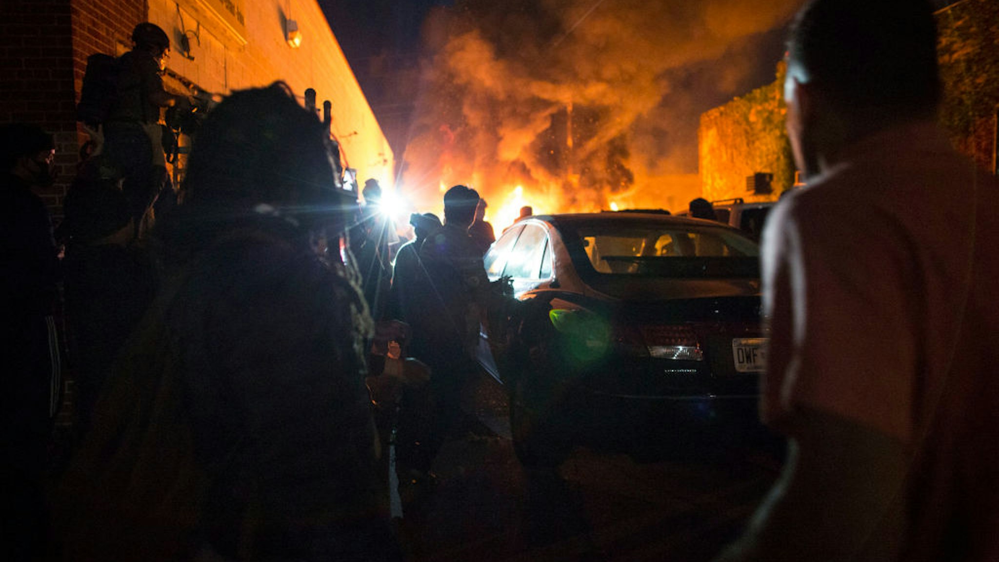 Protesters set fire to a car lot on the corner of Lake street and Park Ave. on Friday night, May 29, 2020. Protesting continues for a third day in response to the death of George Floyd.