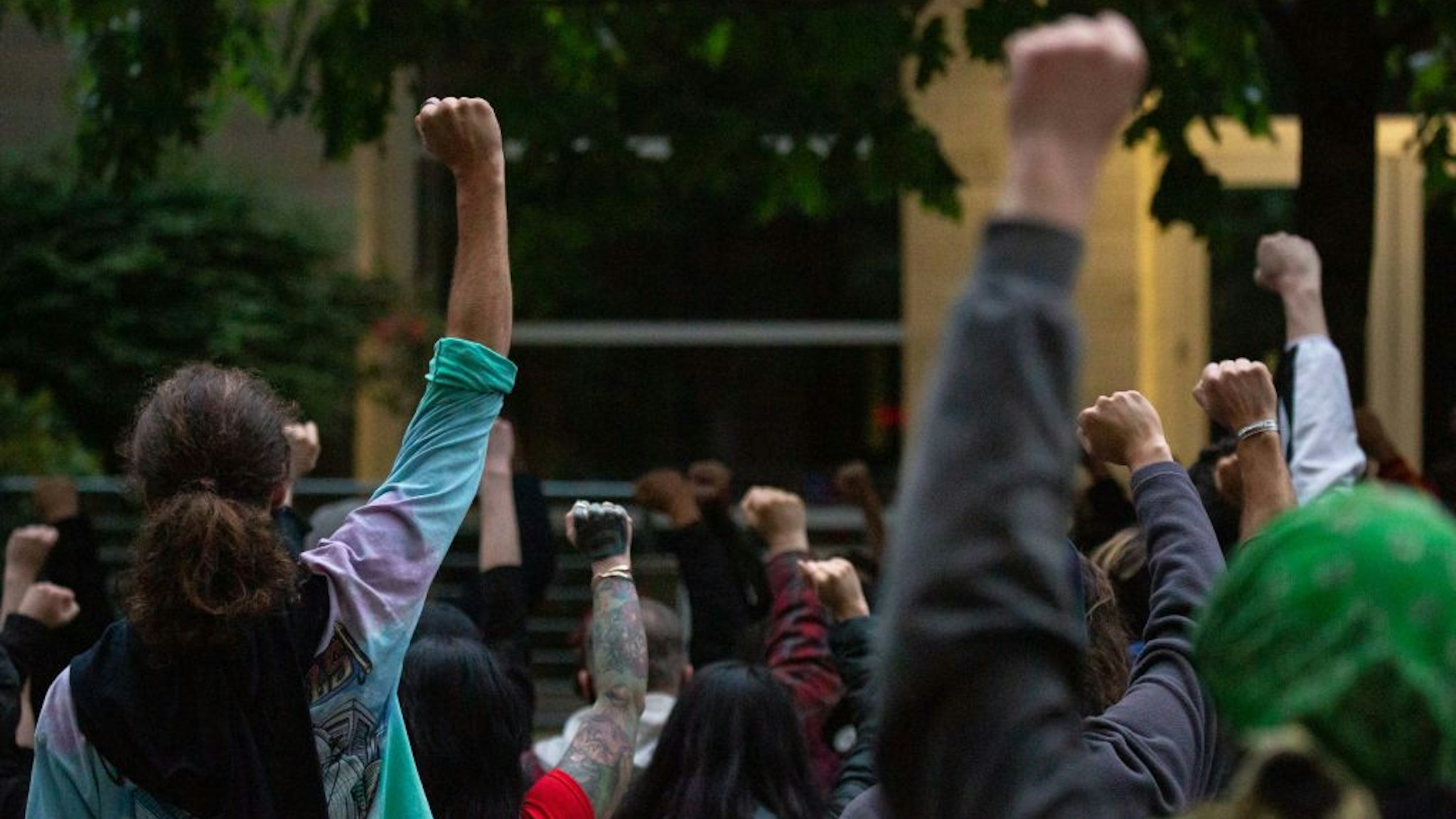 Protesters gather at the Seattle Police Department's West Precinct after marching from the police-free zone known as the Capitol Hill Organized Protest (CHOP) on June 15, 2020 in Seattle, Washington.