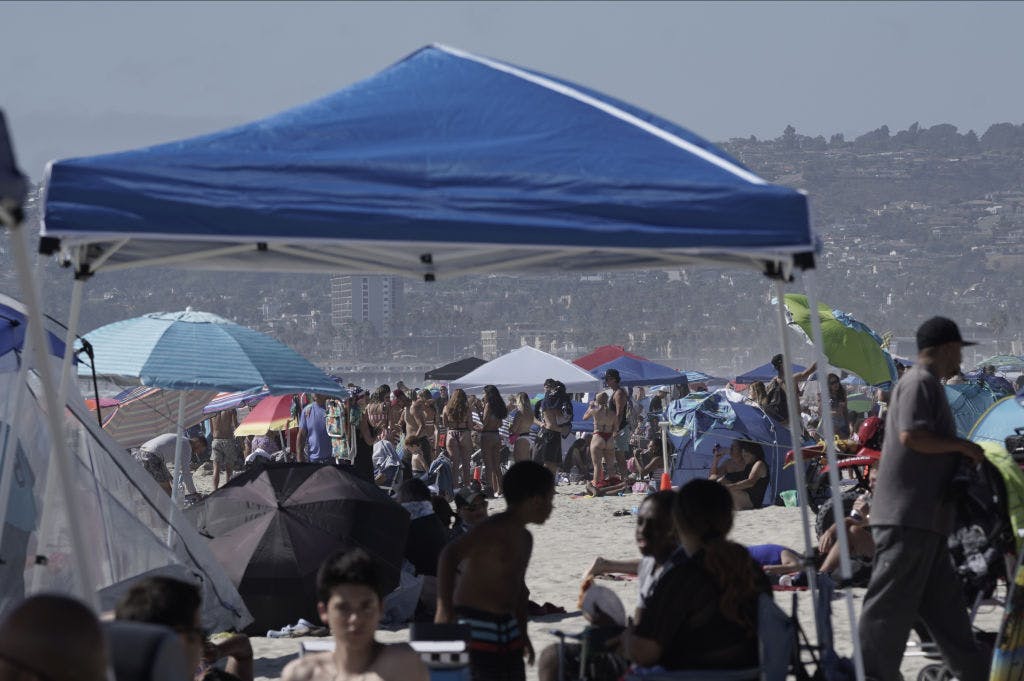 People gather at Mission Beach in San Diego, California.