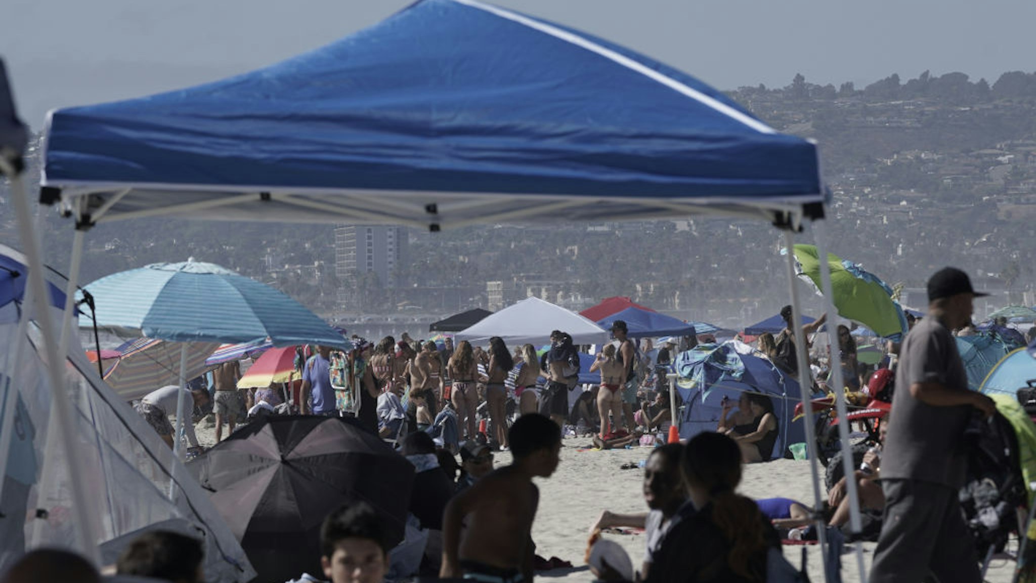 People gather at Mission Beach in San Diego, California.