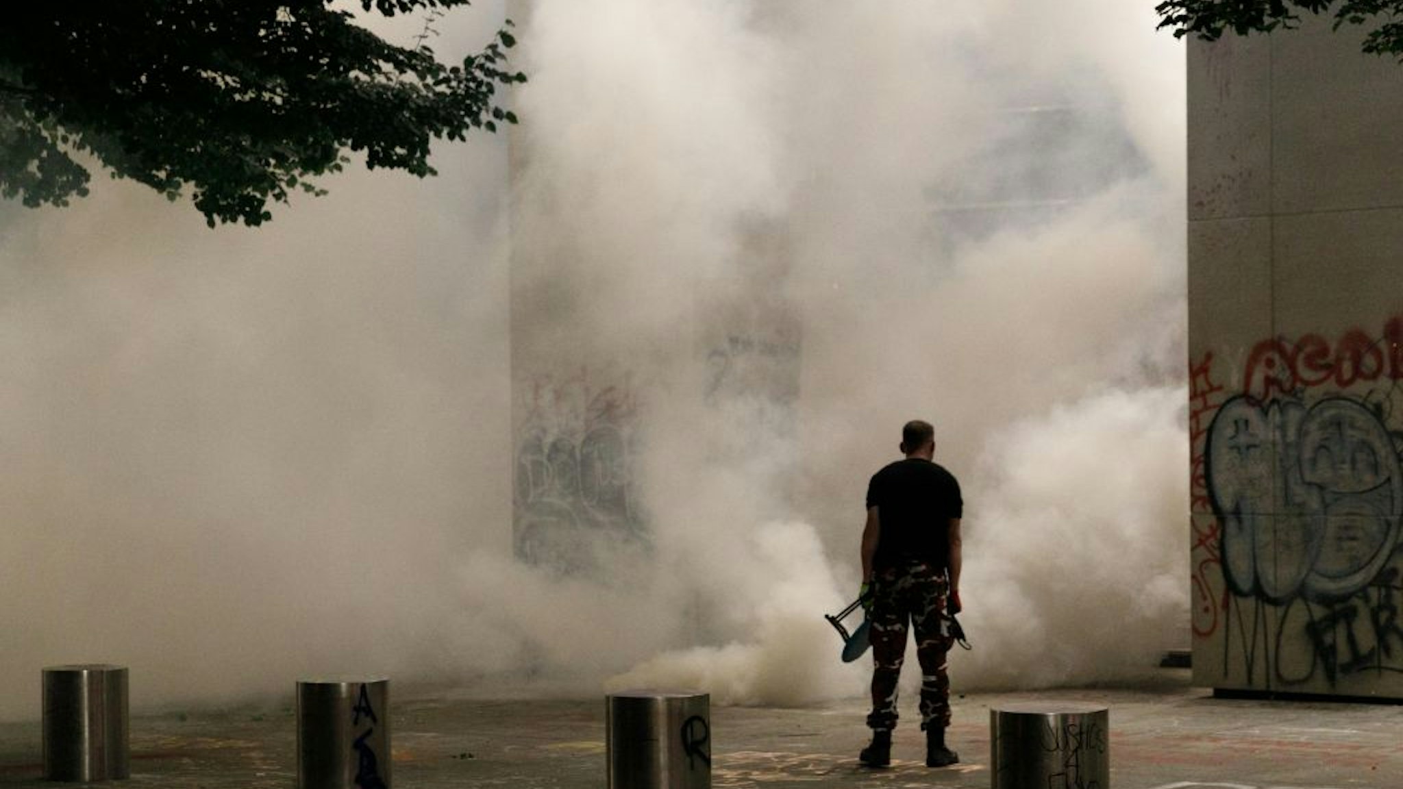 PORTLAND, OREGON, USA: Tear gas and fireworks mix as Black Lives Matter supporters demonstrate in Portland, Oregon on July 4, 2020 for the thirty-eighth day in a row at Portland's Justice Center and throughout Portland, with a riot declared about 12.20 am on July 5. CS tear gas and less-lethal weapons were used, and multiple arrests were made. (Photo by John Rudoff/Anadolu Agency via Getty Images)