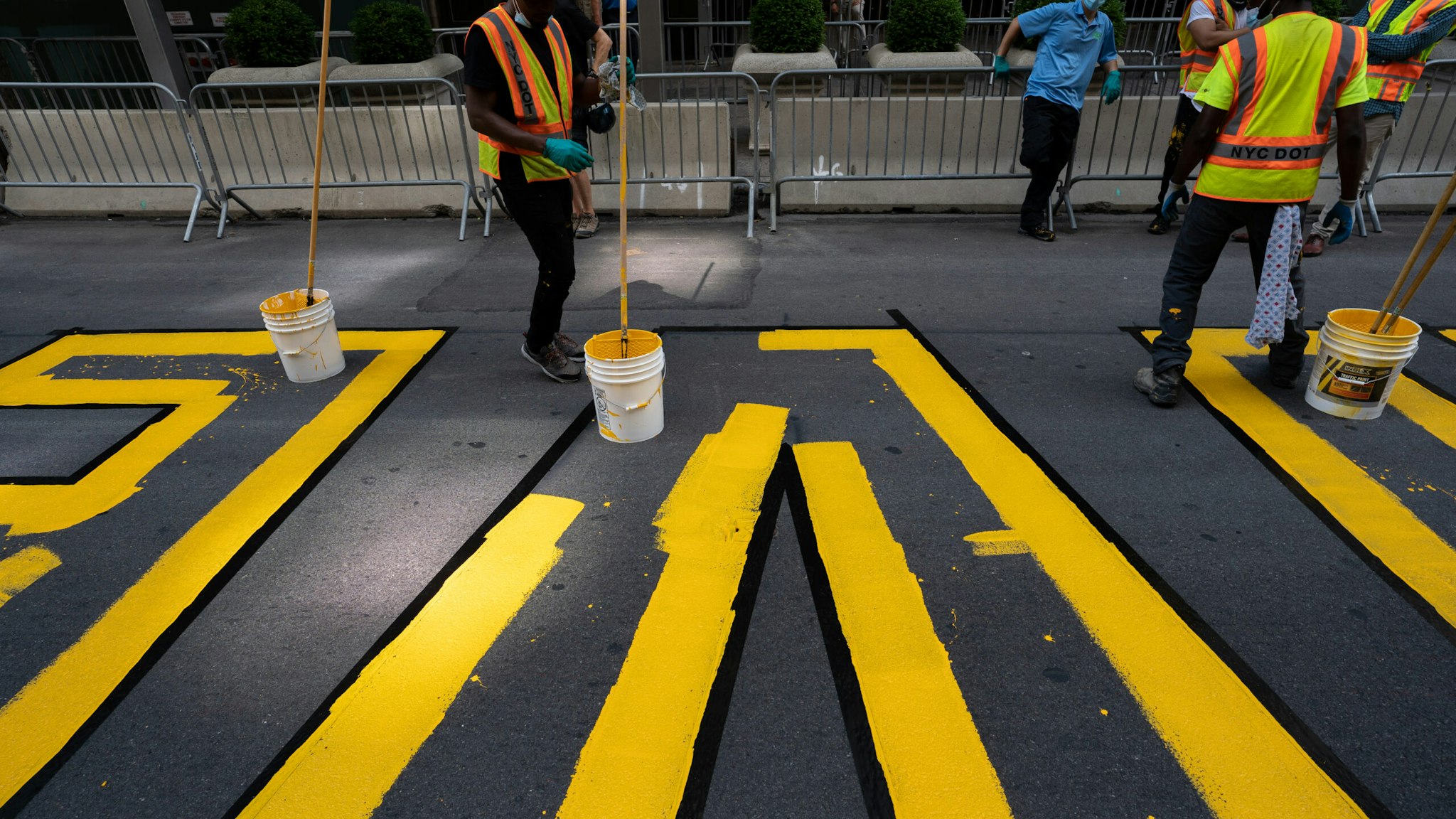 NEW YORK, NY - JULY 09: Crews begin painting a Black Lives Matter mural on Fifth Avenue directly in front of Trump Tower on July 9, 2020 in New York City. In a tweet, President Trump called the mural a "symbol of hate" and said that it would be "denigrating this luxury Avenue". (Photo by David Dee Delgado/Getty Images)