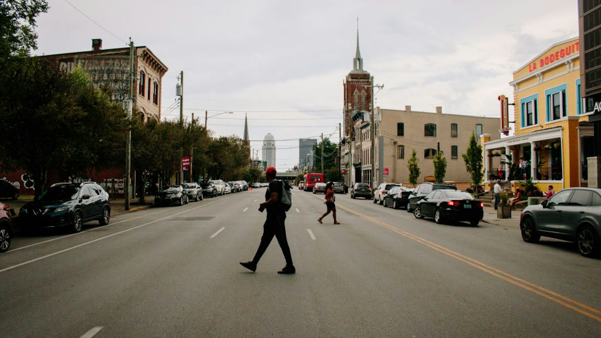 Pedestrians cross a street in the East Market District (also referred to as NuLu neighborhood) in Louisville, Kentucky, U.S., on Thursday, July 23, 2020.