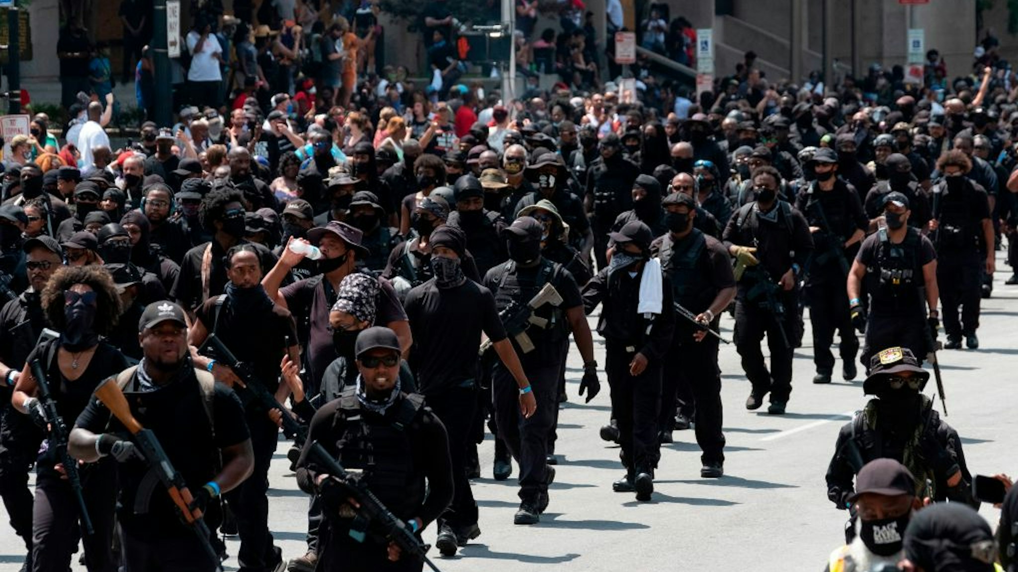 Graphic content / Members of the "Not Fucking Around Coalition" (NFAC), an all black militia, march during a rally to protest the killing of Breonna Taylor, in Louisville, Kentucky on July 25, 2020.