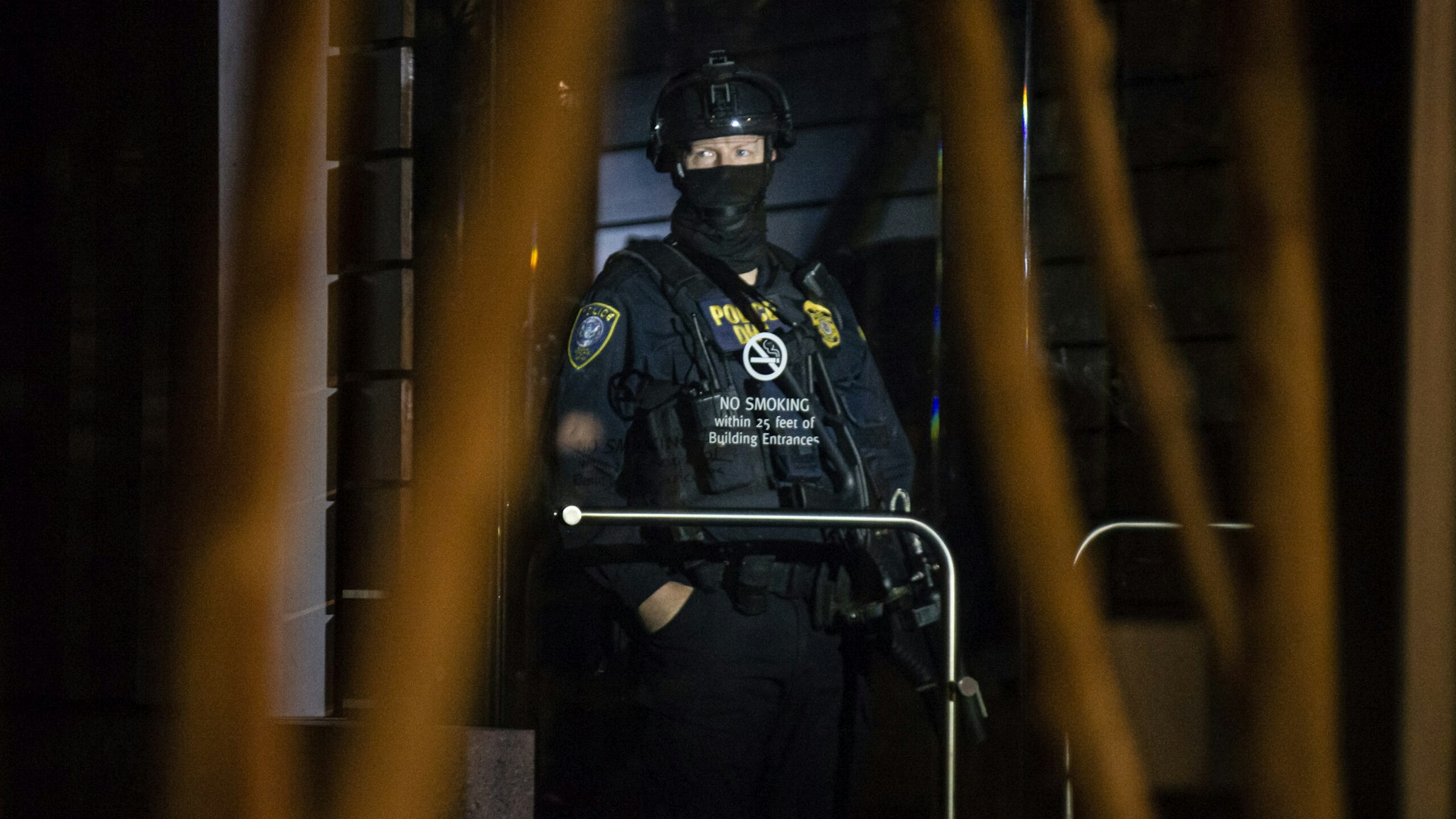 PORTLAND, OR - AUGUST 2: A federal officer guards the interior of the Edith Green - Wendell Wyatt Federal Building early in the morning on August 2, 2020 in Portland, Oregon. Federal officers began a phased withdrawal from the city on Thursday while leaving behind personnel inside the two downtown federal buildings. (Photo by Nathan Howard/Getty Images)
