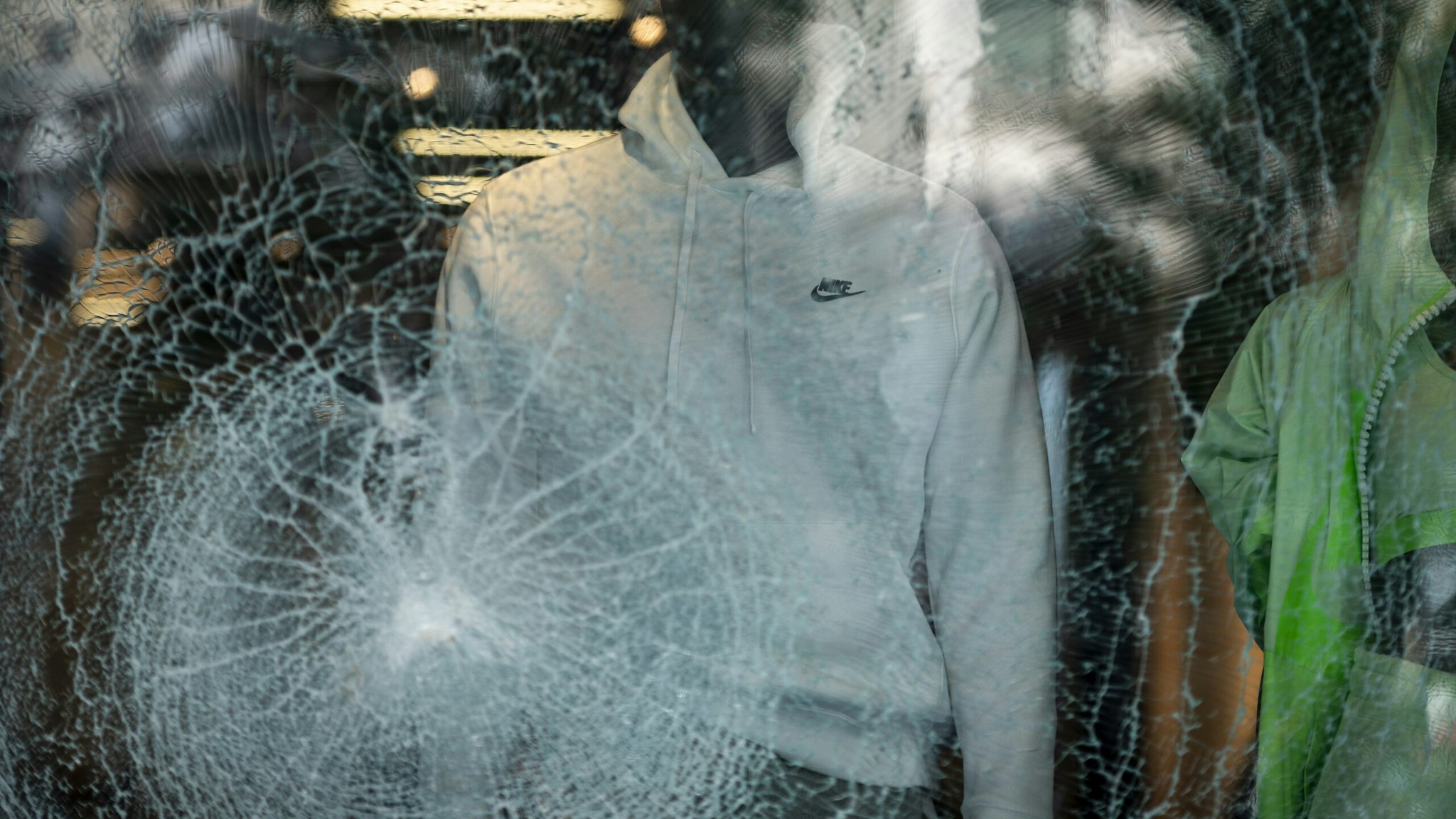 The glass window display of a Nike Inc. store stands shattered following looting on Michigan Avenue in Chicago, Illinois, U.S., on Monday, Aug. 10, 2020. Chicago police arrested more than 100 people for looting, disorderly conduct and battery against officers, among other charges, as crowds of people descended upon the city's downtown overnight, Superintendent David Brown said during a press conference Monday. Photographer: Christopher Dilts/Bloomberg via Getty Images