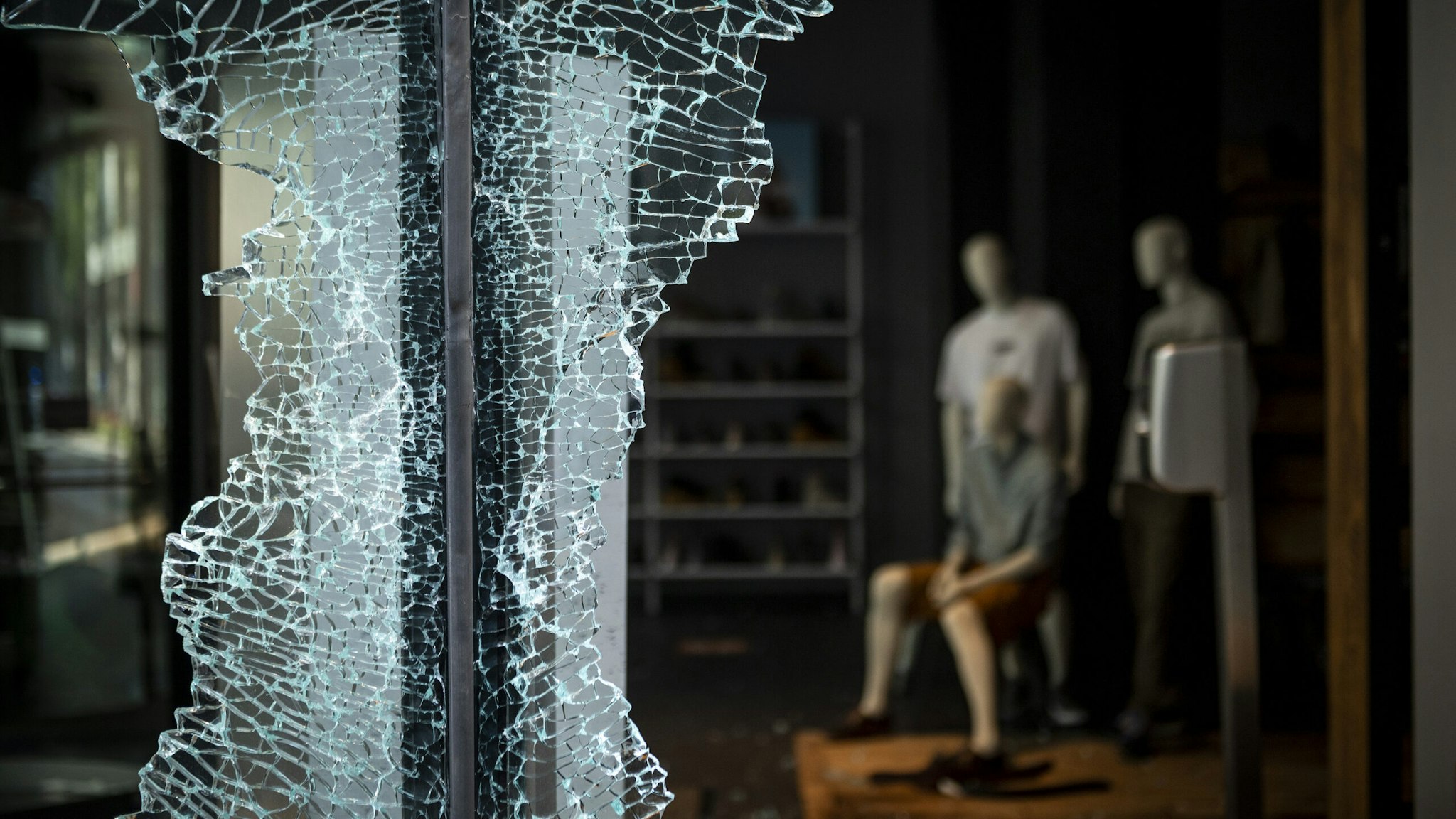Shattered glass remains on the window frame of a Timberland LLC store following looting on Michigan Avenue in Chicago, Illinois, U.S., on Monday, Aug. 10, 2020. Chicago police arrested more than 100 people for looting, disorderly conduct and battery against officers, among other charges, as crowds of people descended upon the city's downtown overnight, Superintendent David Brown said during a press conference Monday. Photographer: Christopher Dilts/Bloomberg via Getty Images
