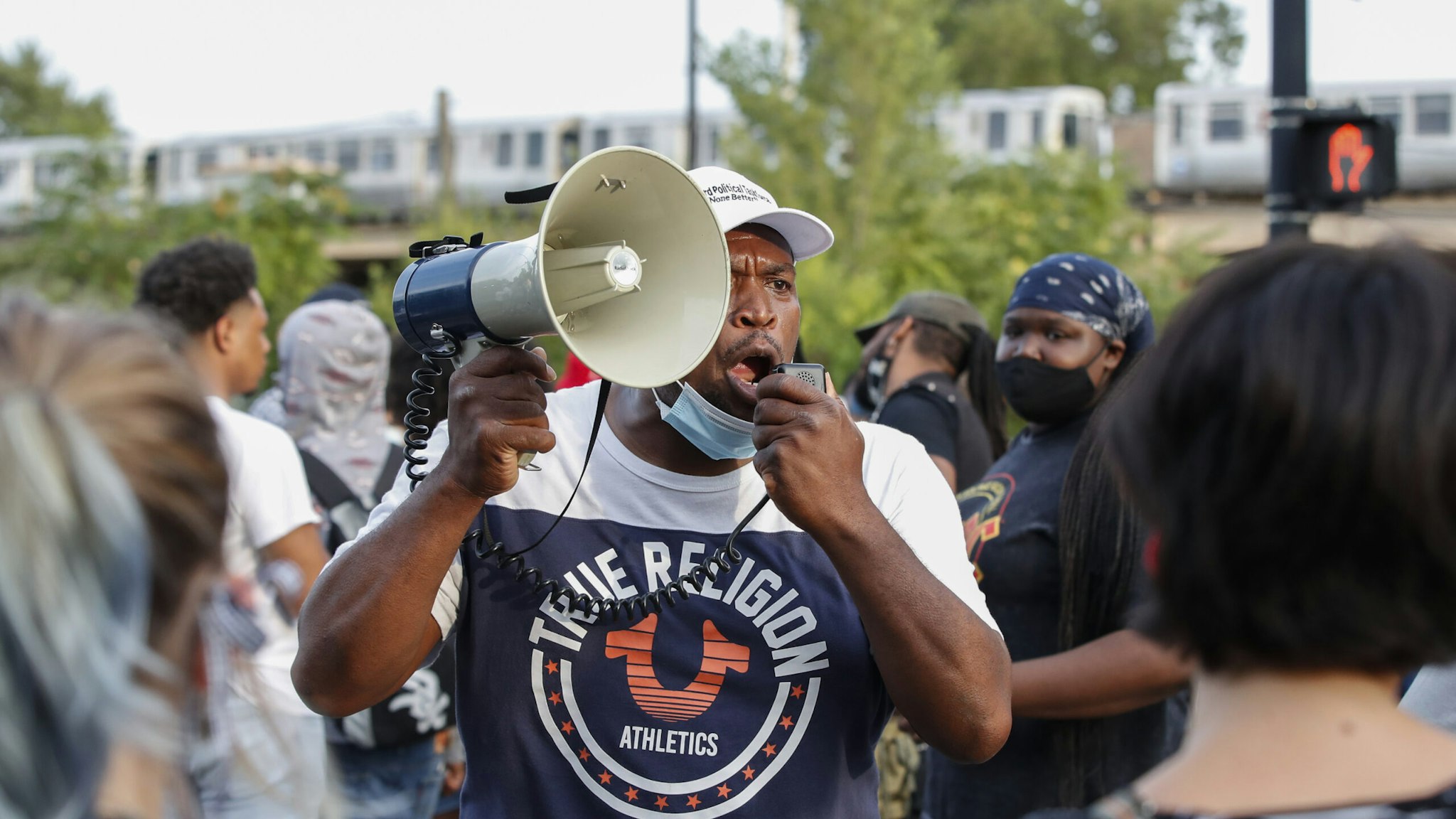 A man shouts into a megaphone against the presence of protesters during a rally against Chicago Police violence in the Englewood neighborhood of Chicago, Illinois, on August 11, 2020. (Photo by KAMIL KRZACZYNSKI / AFP) (Photo by KAMIL KRZACZYNSKI/AFP via Getty Images)