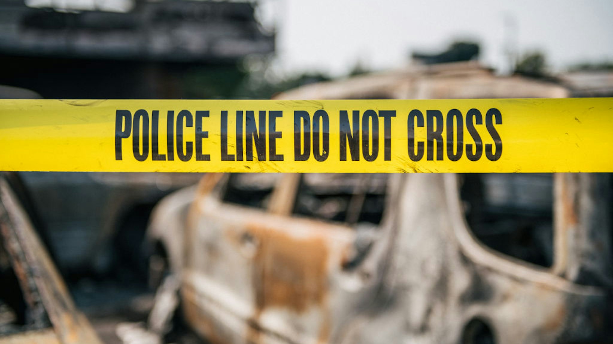 KENOSHA, WI - AUGUST 24: Caution tape at a burned down used car lot on August 24, 2020 in Kenosha, Wisconsin. A night of civil unrest occurred after the shooting of Jacob Blake, 29, on August 23. Blake was shot multiple times in the back by Wisconsin police officers after attempting to enter into the drivers side of a vehicle. (Photo by Brandon Bell/Getty Images)