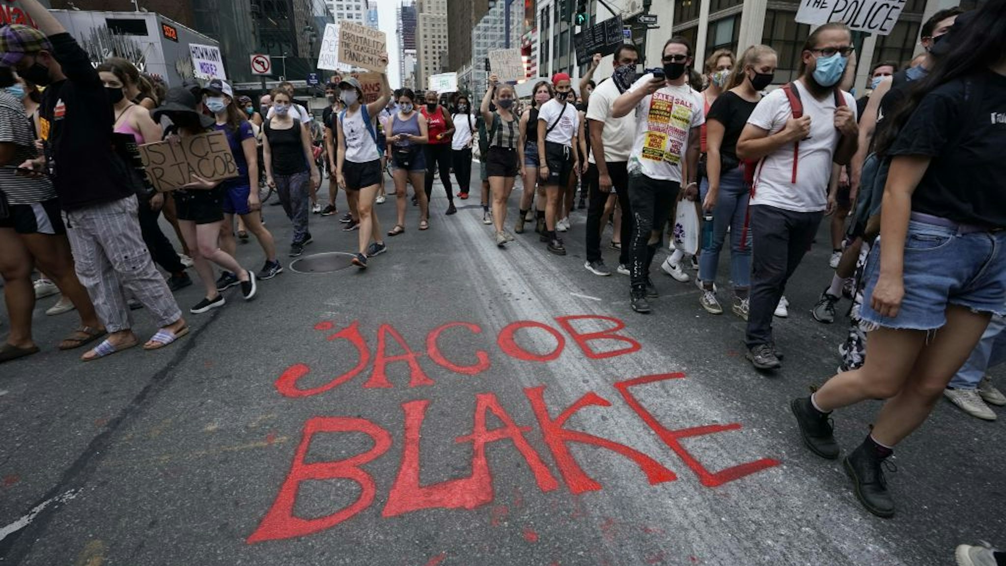 TOPSHOT - Demonstrators march through the city during a protest in New York August 24, 2020 against the shooting of Jacob Blake who shot in the back multiple times by police in Kenosha, Wisconsin, on Sunday, prompting community protests. - A video showing Wisconsin police shooting a black man in the back in front of his children sparked outrage across the United States on Monday, with officials calling in the national guard as they girded for a second night of violent protests. (Photo by TIMOTHY A. CLARY / AFP) (Photo by TIMOTHY A. CLARY/AFP via Getty Images)
