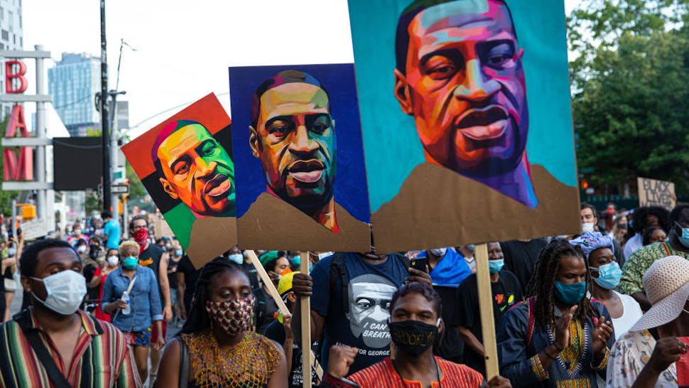 Juneteenth Marked With Celebrations And Marches In Cities Across America Pedestrians carry posters with the picture of George Floyd who was killed in police custody three weeks earlier in Minneapolis, Minnesota during the Juneteenth protest march on June 19, 2020 in the Brooklyn borough of New York City.