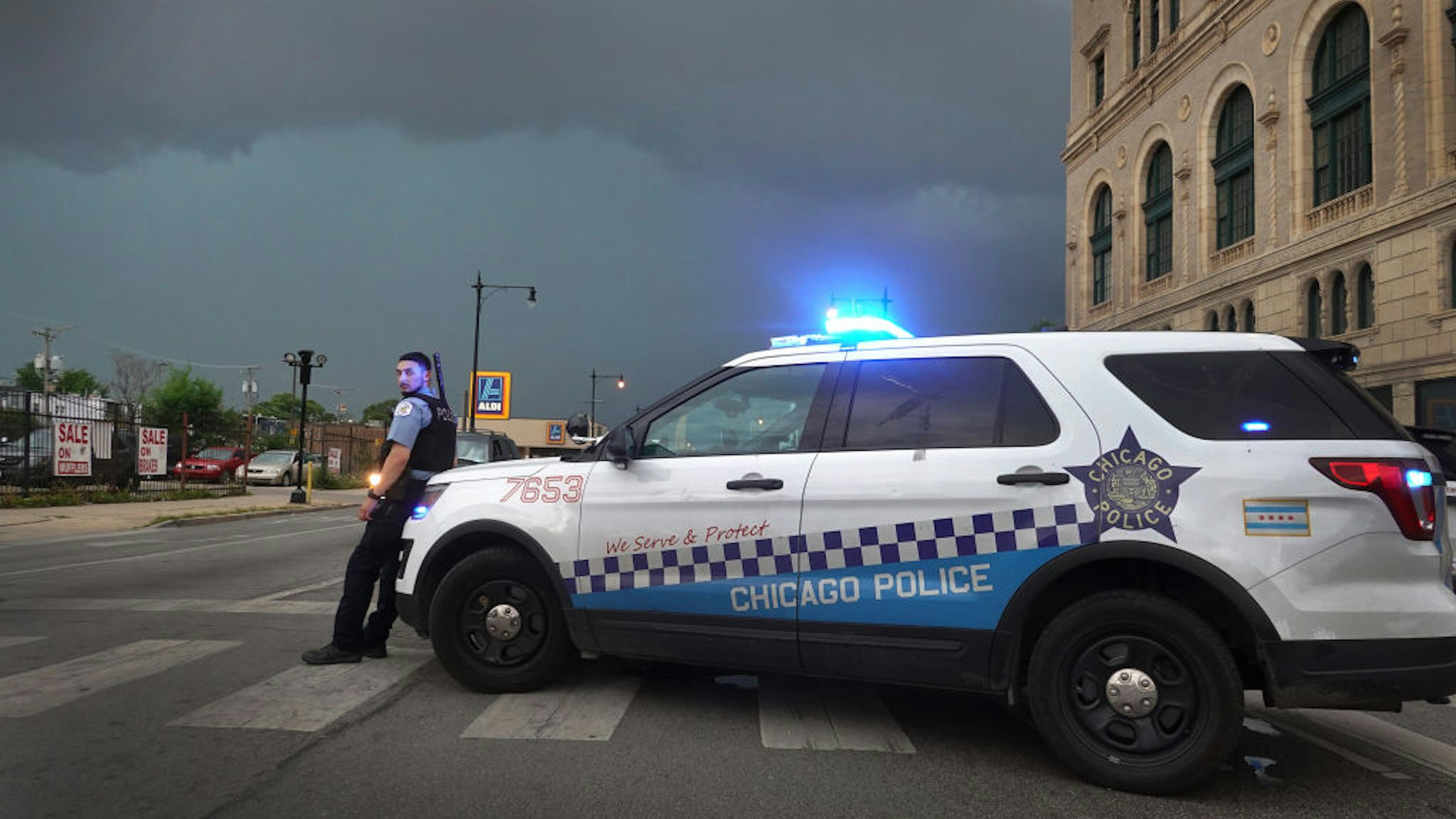 CHICAGO, ILLINOIS - AUGUST 10: A police officer stands guard following unrest on the city's westside moments before a derecho storm hits the area on August 10, 2020 in Chicago, Illinois. The storm, with winds gusts close to 100 miles per hour, downed trees and power lines as it moved through the city and suburbs. (Photo by Scott Olson/Getty Images)