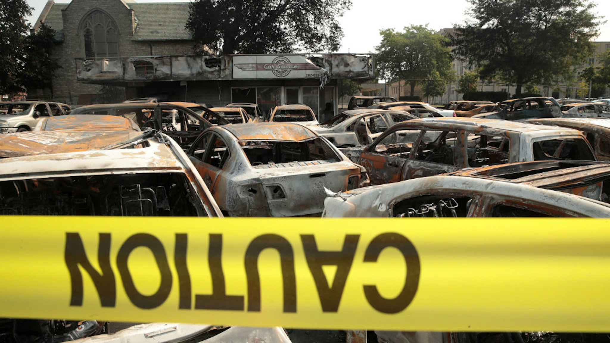 KENOSHA, WISCONSIN - AUGUST 24: Vehicles sit burned out at a used car lot after a night of unrest, on August 24, 2020 in Kenosha, Wisconsin. The unrest stemmed from an incident in which police shot a Black man multiple times in the back as he entered the driver's side door of a vehicle. (Photo by Scott Olson/Getty Images)