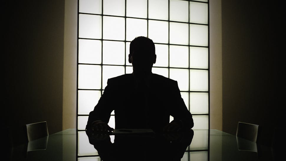 Business man or boss in silhouette interview - stock photo