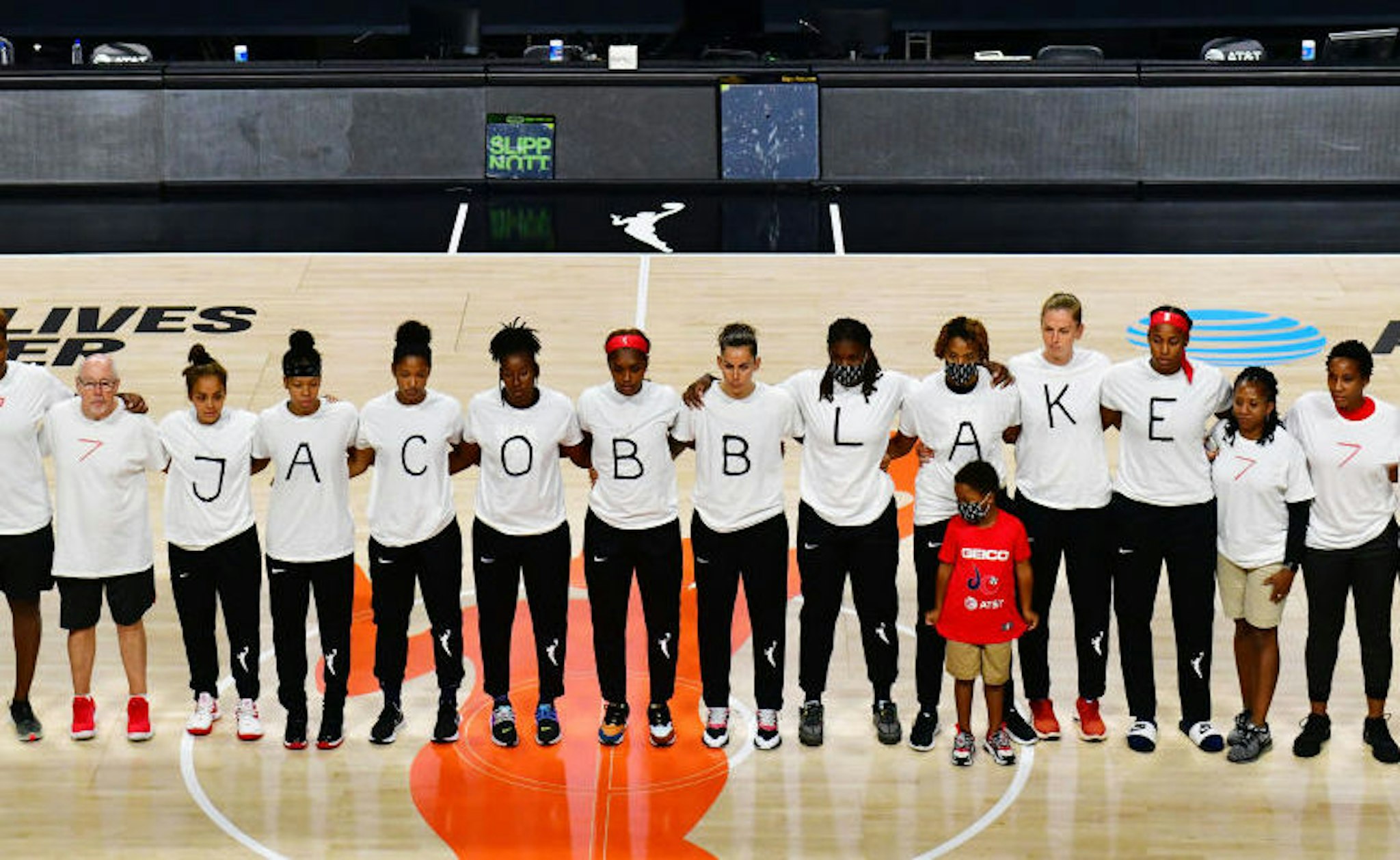After the WNBA announcement of the postponed games for the evening, the Washington Mystics each wear white T-shirts with seven bullets on the back protesting the shooting of Jacob Blake by Kenosha, Wisconsin police at Feld Entertainment Center on August 26, 2020 in Palmetto, Florida. NOTE TO USER: User expressly acknowledges and agrees that, by downloading and or using this photograph, User is consenting to the terms and conditions of the Getty Images License Agreement. (Photo by Julio Aguilar/Getty Images)