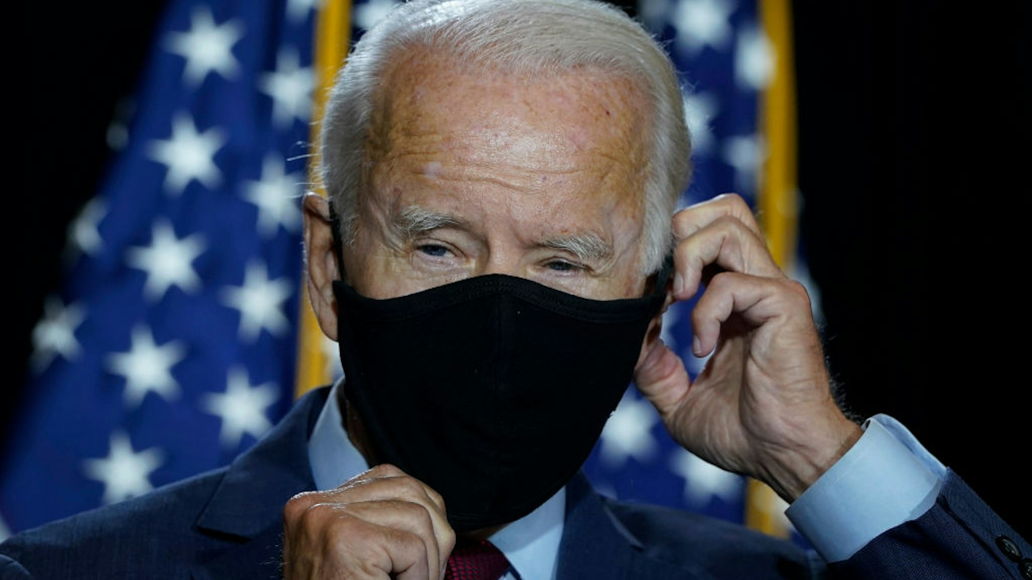 WILMINGTON, DE - AUGUST 13: Presumptive Democratic presidential nominee former Vice President Joe Biden puts his mask back on after delivering remarks following a coronavirus briefing with health experts at the Hotel DuPont on August 13, 2020 in Wilmington, Delaware. Harris is the first Black woman and first person of Indian descent to be a presumptive nominee on a presidential ticket by a major party in U.S. history. (Photo by Drew Angerer/Getty Images)