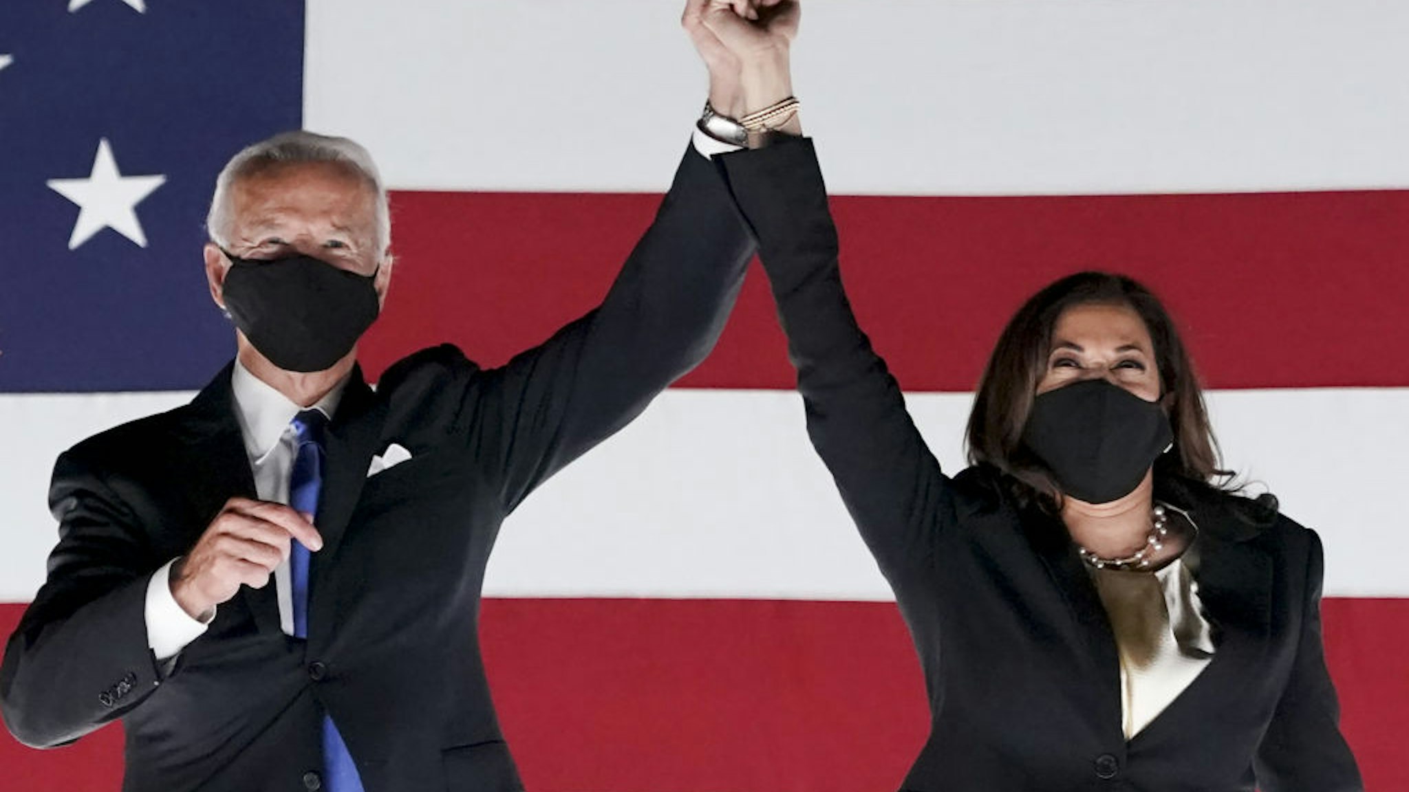 Former Vice President Joe Biden, Democratic presidential nominee, left, and Senator Kamala Harris, Democratic vice presidential nominee, wear protective masks while holding hands outside the Chase Center during the Democratic National Convention in Wilmington, Delaware, U.S., on Thursday, Aug. 20, 2020. Biden accepted the Democratic nomination to challenge President Donald Trump, urging Americans in a prime-time address to vote for new national leadership that will overcome deep U.S. political divisions. Photographer: Stefani Reynolds/Bloomberg