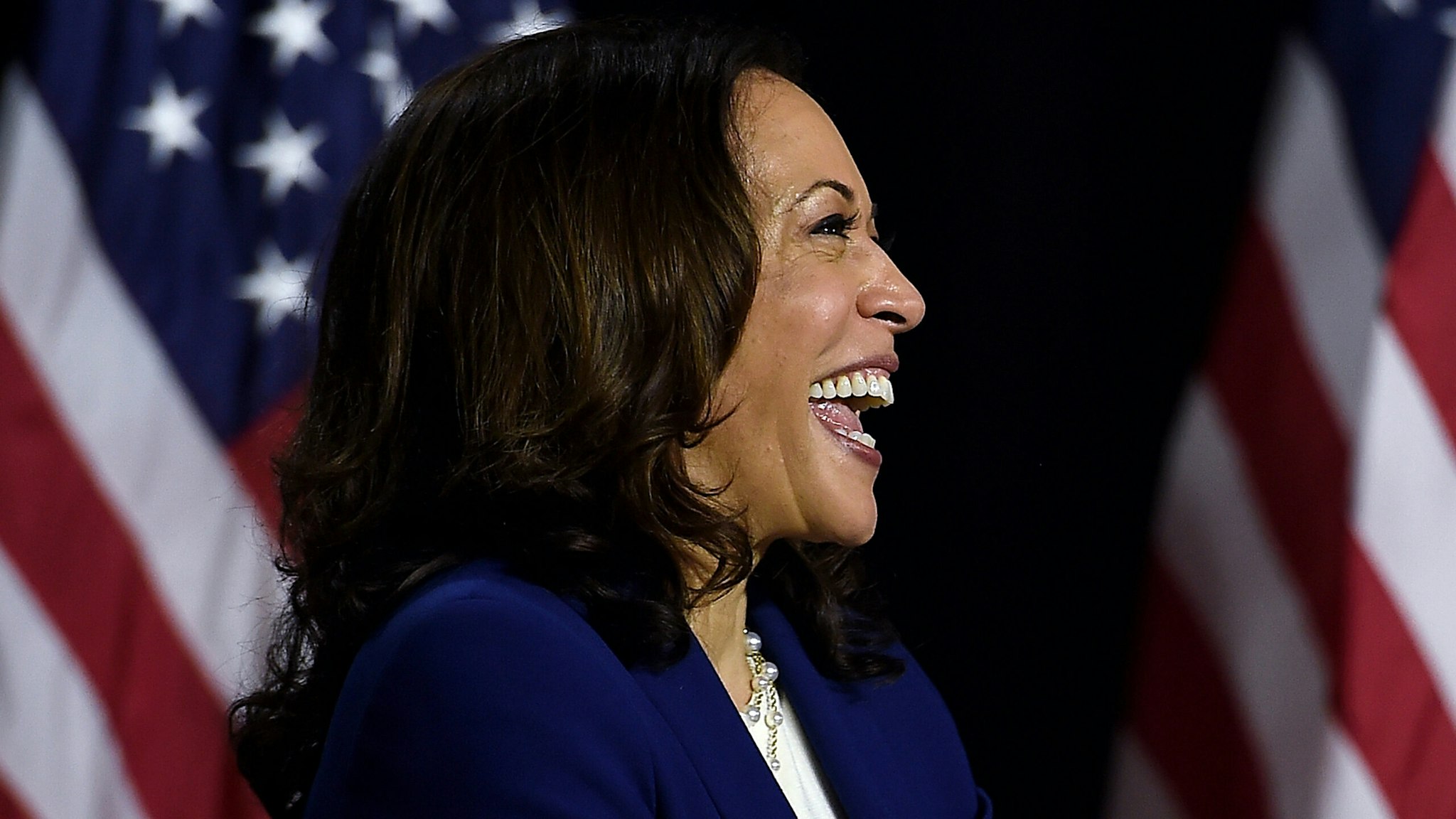 Democratic vice presidential running mate, US Senator Kamala Harris, laughs as she listens to presidential nominee and former US Vice President Joe Biden speak during their first press conference together in Wilmington, Delaware, on August 12, 2020.