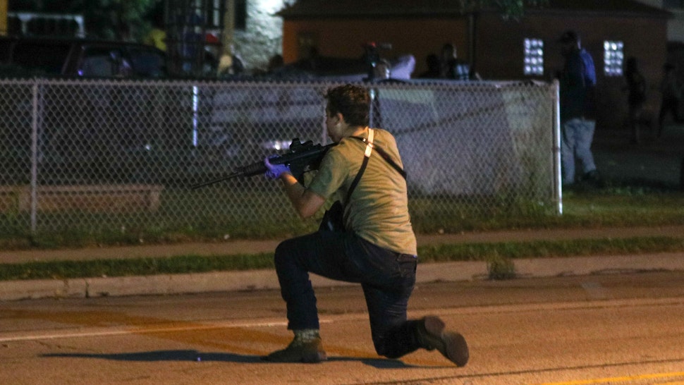 KENOSHA, WISCONSIN, USA - AUGUST 25: (EDITORS NOTE: Image contains graphic content.) A man on the ground was shot in the chest as clashes between protesters and armed civilians who protect the streets of Kenosha against the arson during the third day of protests over the shooting of a black man Jacob Blake by police officer in Wisconsin, United States on August 25, 2020.