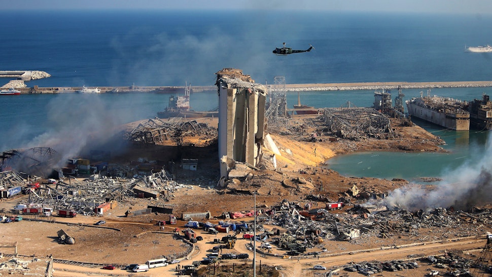 A general view shows the damaged grain silos of Beirut's harbour and its surroundings on August 5, 2020, one day after a powerful twin explosion tore through Lebanon's capital, resulting from the ignition of a huge depot of ammonium nitrate at the city's main port. - Rescuers searched for survivors in Beirut after a cataclysmic explosion at the port sowed devastation across entire neighbourhoods, killing more than 100 people, wounding thousands and plunging Lebanon deeper into crisis. The blast, which appeared to have been caused by a fire igniting 2,750 tonnes of ammonium nitrate left unsecured in a warehouse, was felt as far away as Cyprus, some 150 miles (240 kilometres) to the northwest.