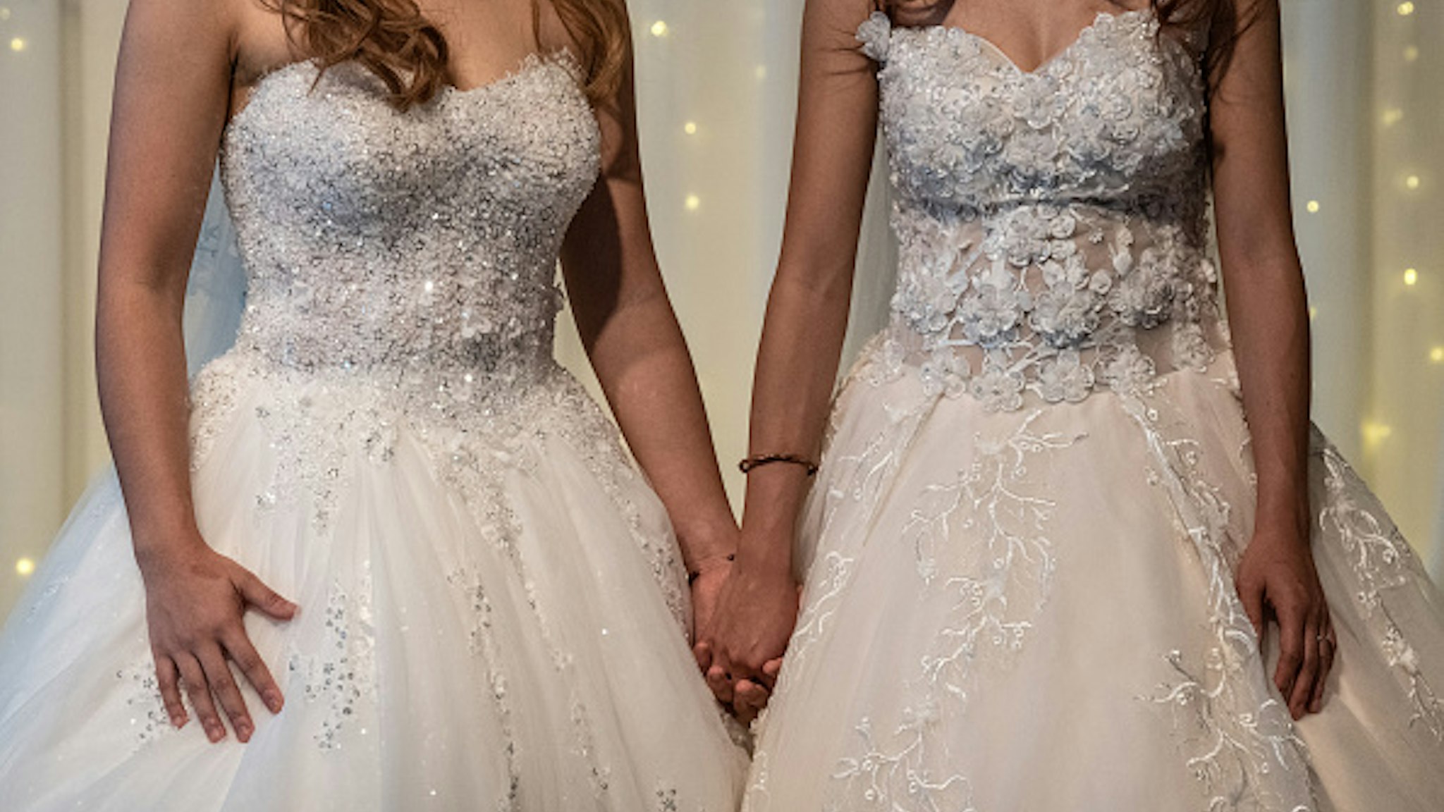 TAIPEI, TAIWAN - MAY 18: Lesbian couple Amber and Huan Huan hold hands during a wedding event to raise HIV awareness a day after Taiwan's parliament voted to legalise same-sex marriage, on May 18, 2019 in Taipei, Taiwan. Taiwan yesterday became the first country in Asia to legalise same-sex marriage after lawmakers voted to allow same-sex couples full legal marriage rights, including areas in taxes, insurance and child custody. Thousands of gay rights supporters gathered outside the parliament building in the nation's capital as the result was announced. The bill will go into effect on May 24.