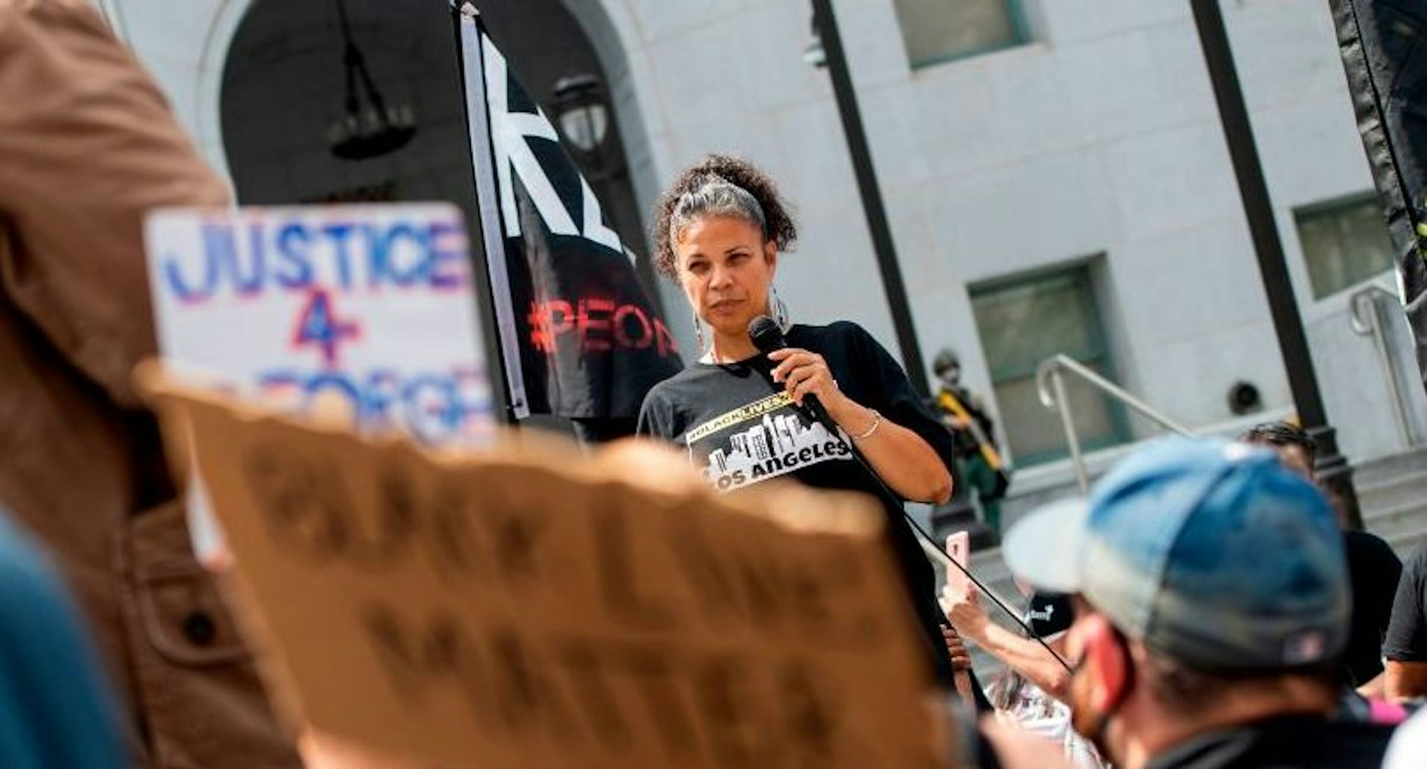 Melina Abdullah from Black Lives Matter addresses the crowd during a demonstration to ask for the removal of District Attorney Jackie Lacey in front of the Hall of Justice, in Los Angeles, California, on June 17, 2020. (Photo by VALERIE MACON / AFP) (Photo by VALERIE MACON/AFP via Getty Images)